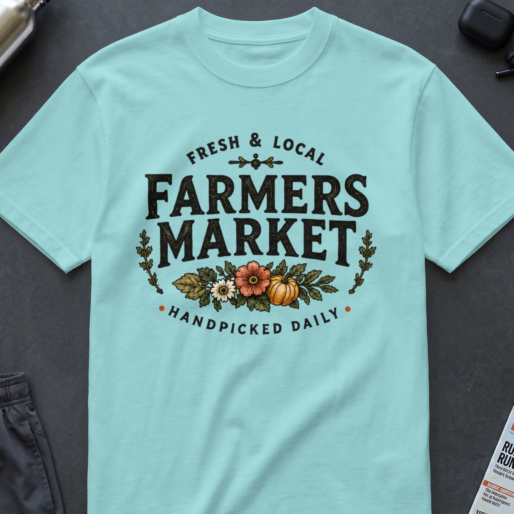 Light blue t-shirt with "FRESH & LOCAL FARMERS MARKET HANDPICKED DAILY" text and floral graphics.