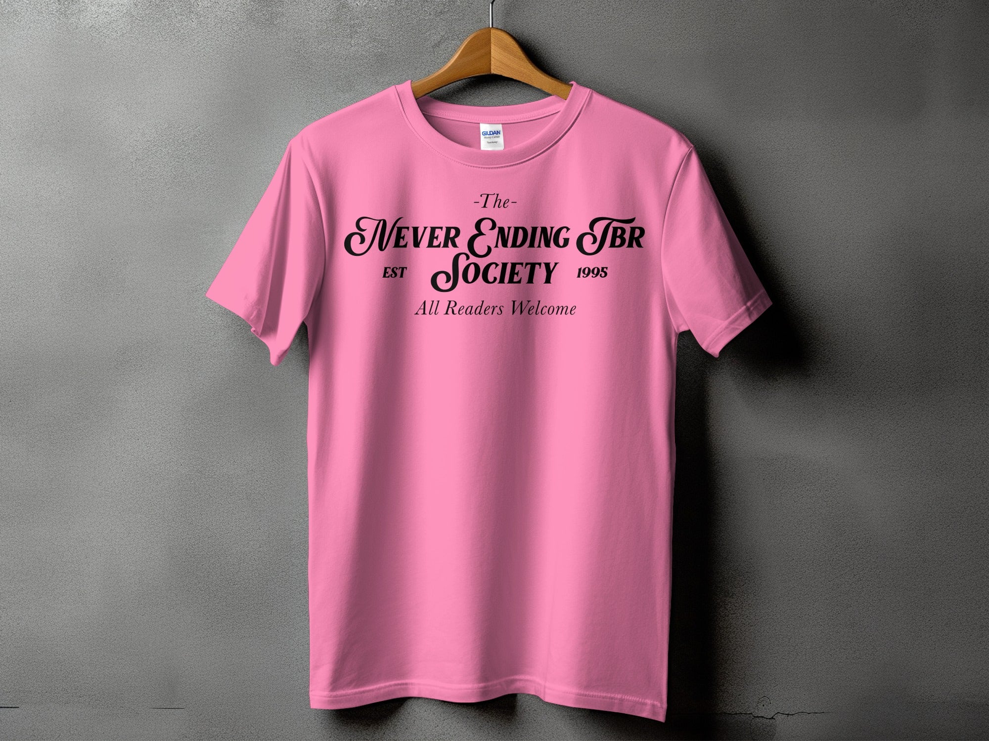Pink t-shirt with black text "The Never Ending TBR Society Est 1995 All Readers Welcome".