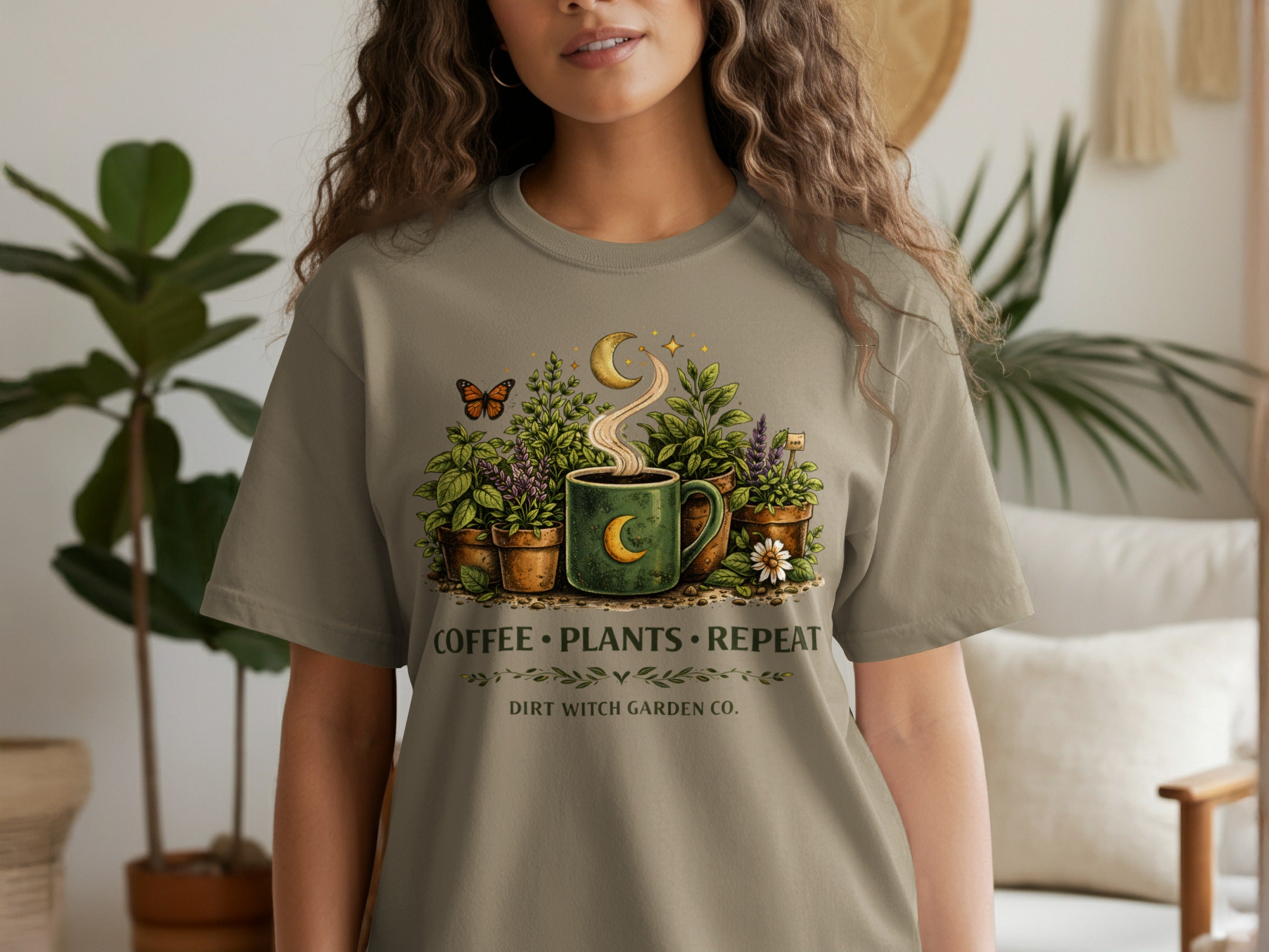 T-shirt graphic: coffee mug with plants, crescent moon, butterfly, and text.
