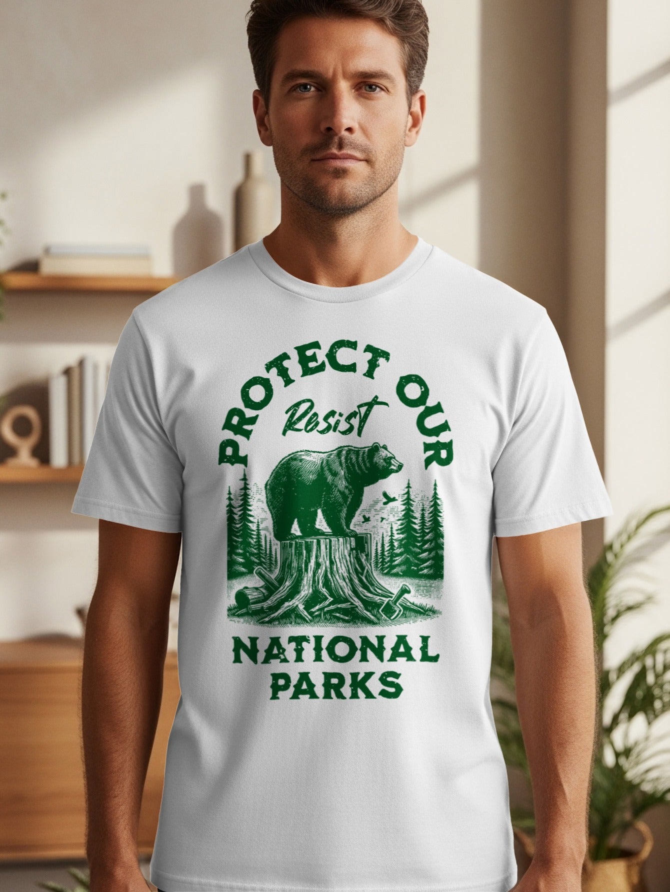 White t-shirt with a green graphic of a bear on a tree stump and text reading "Protect Our National Parks - Resist".