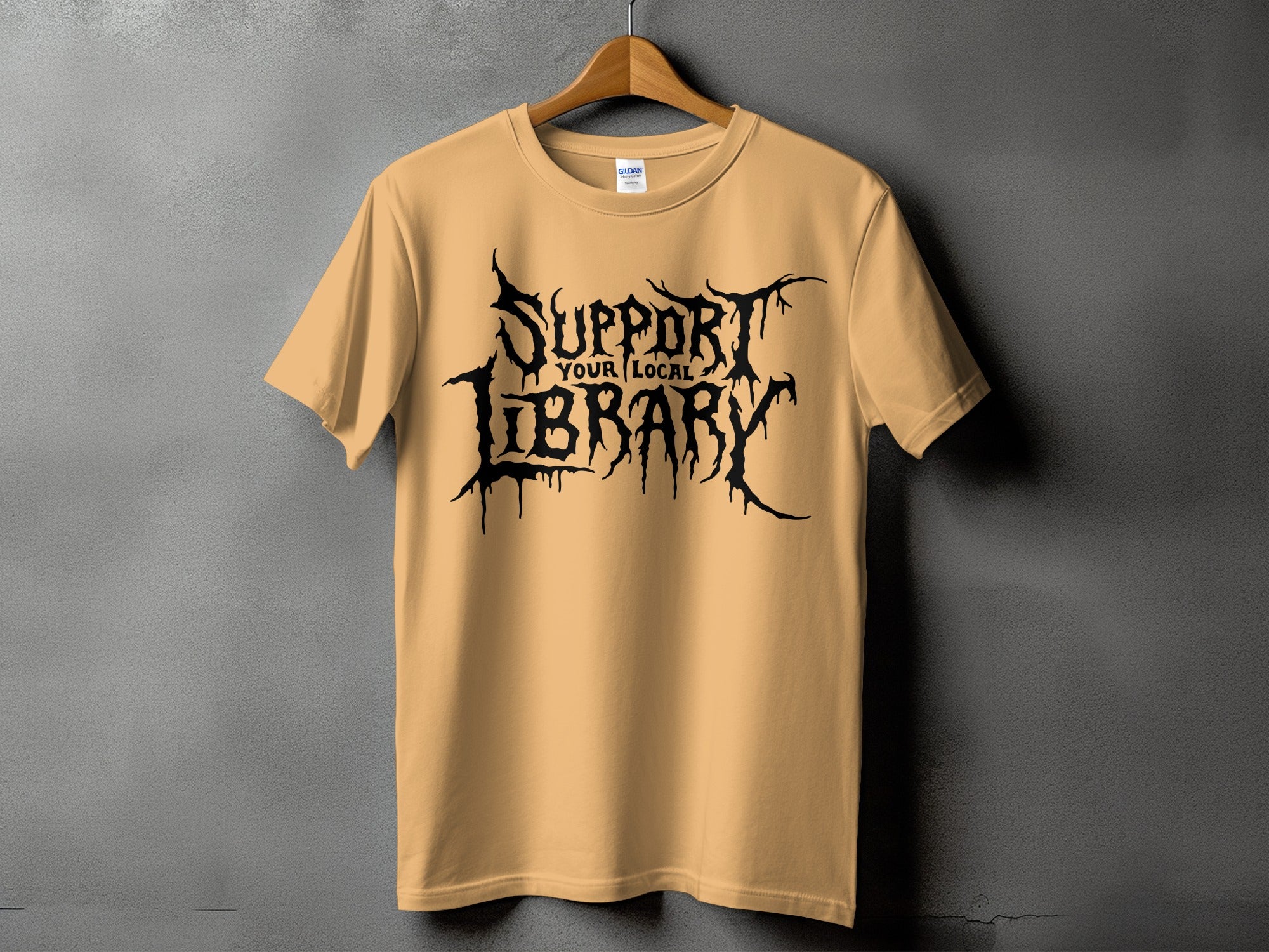 Tan t-shirt with black gothic text reading "Support Your Local Library".