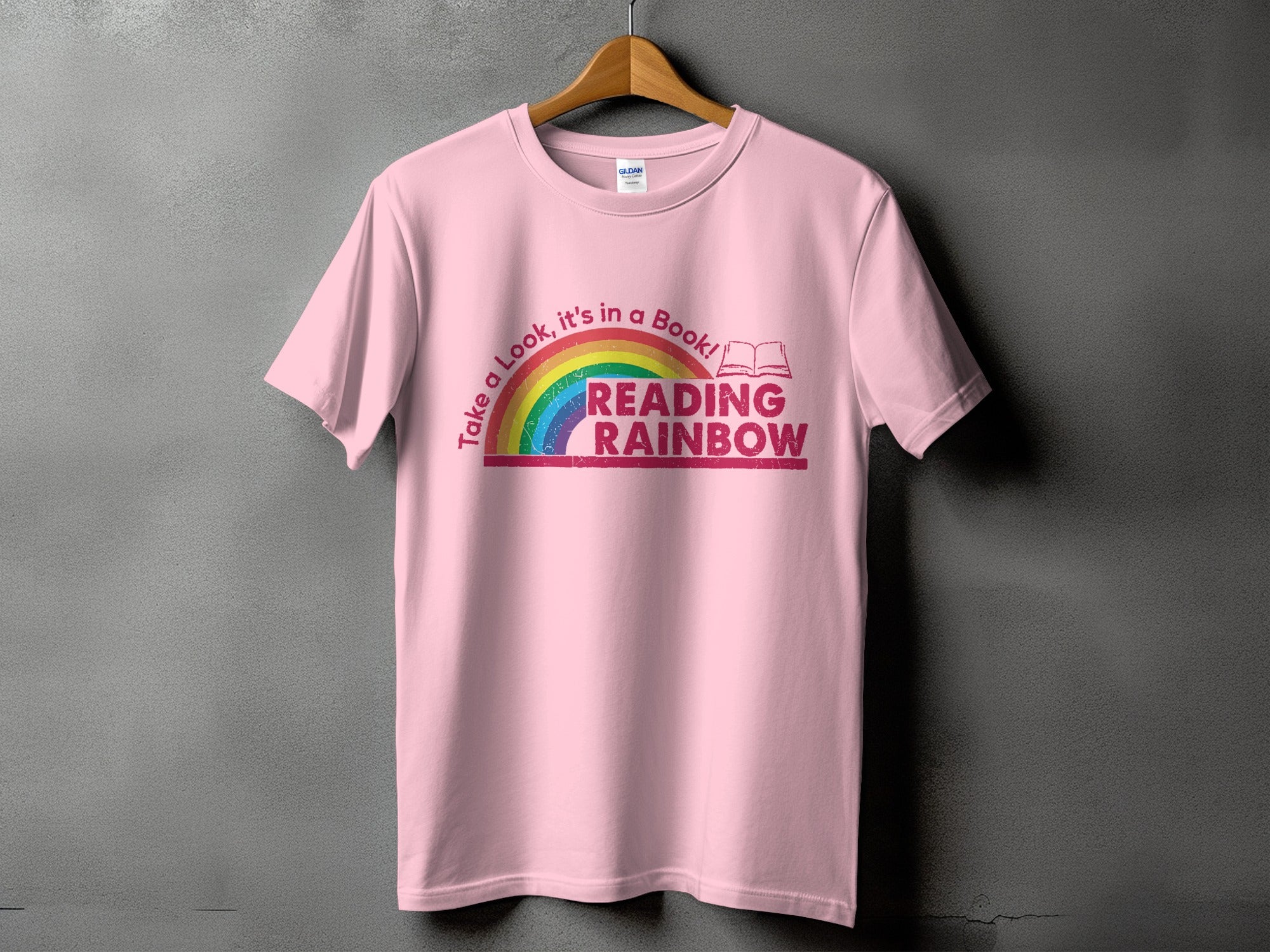 Pink t-shirt with rainbow and "Reading Rainbow" text.
