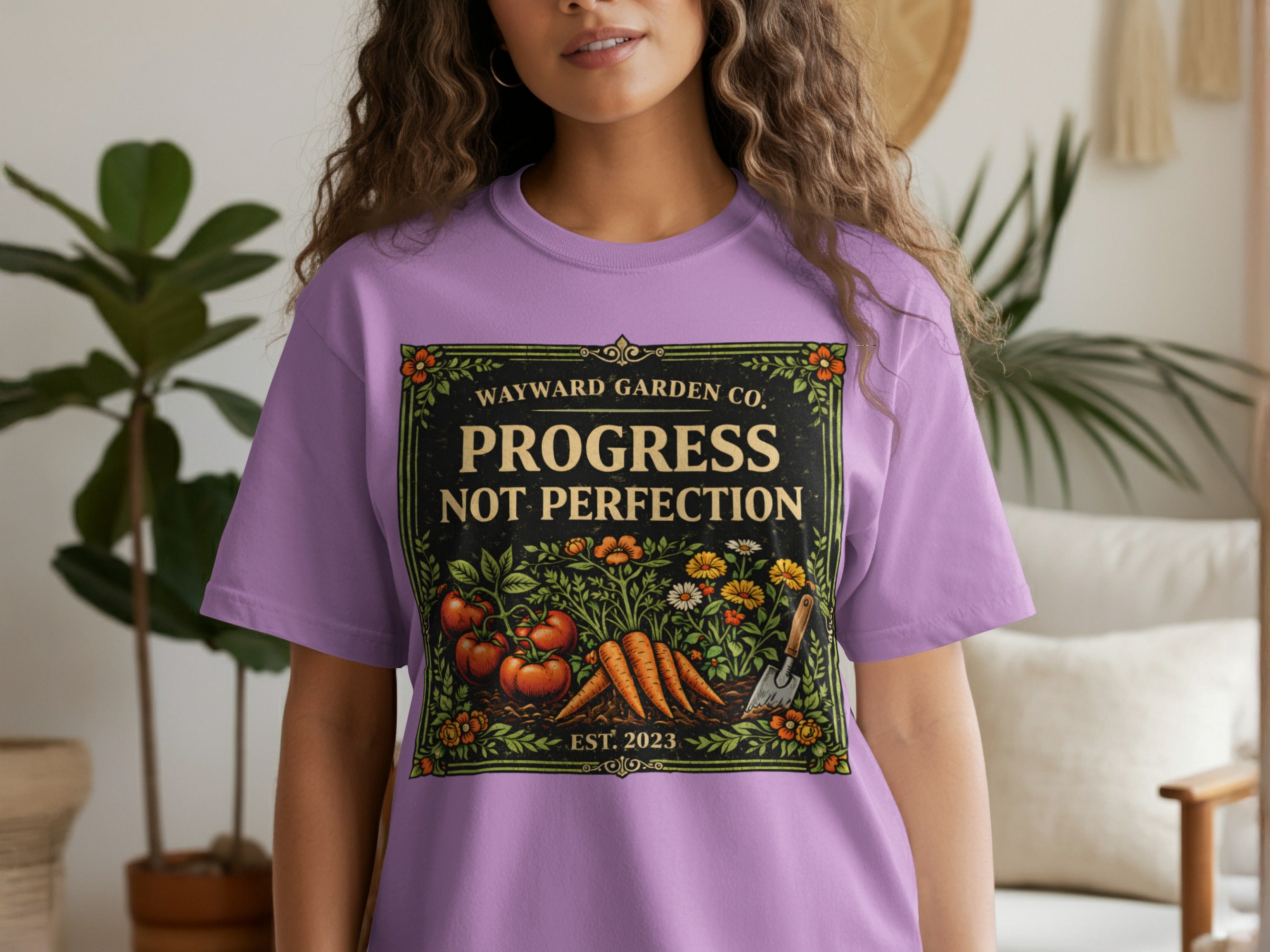 Lavender t-shirt with "Wayward Garden Co. Progress Not Perfection" text and produce graphic.
