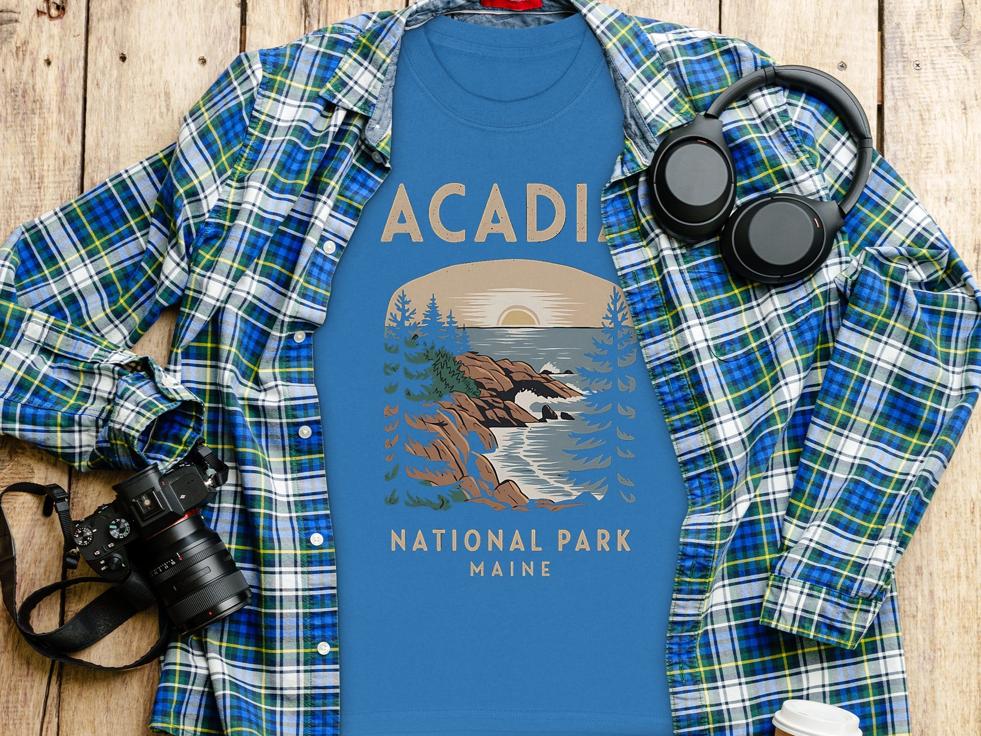 Blue t-shirt with "Acadia National Park Maine" text and coastal graphic.