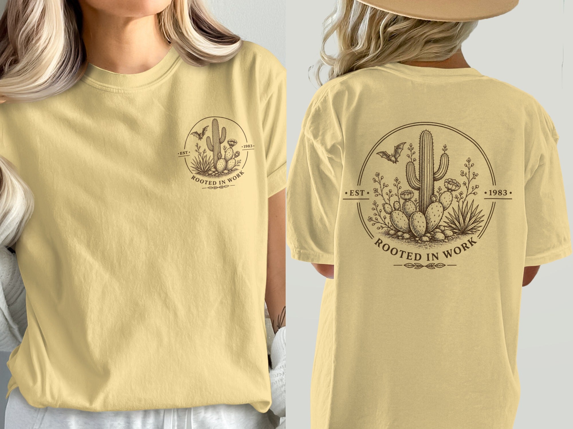 Yellow t-shirt with desert graphic featuring a cactus, bat, and text "Rooted in Work".