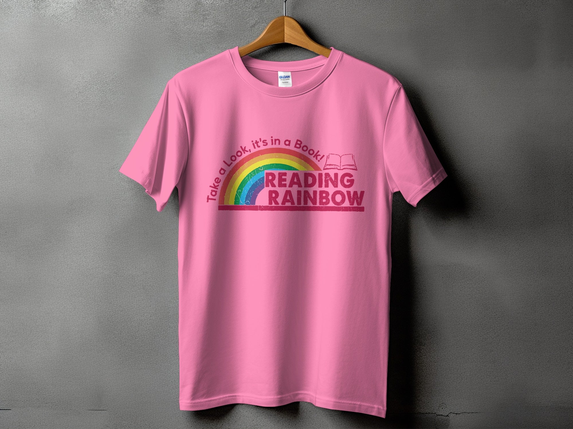 Pink t-shirt with a rainbow and "Reading Rainbow" text graphic.
