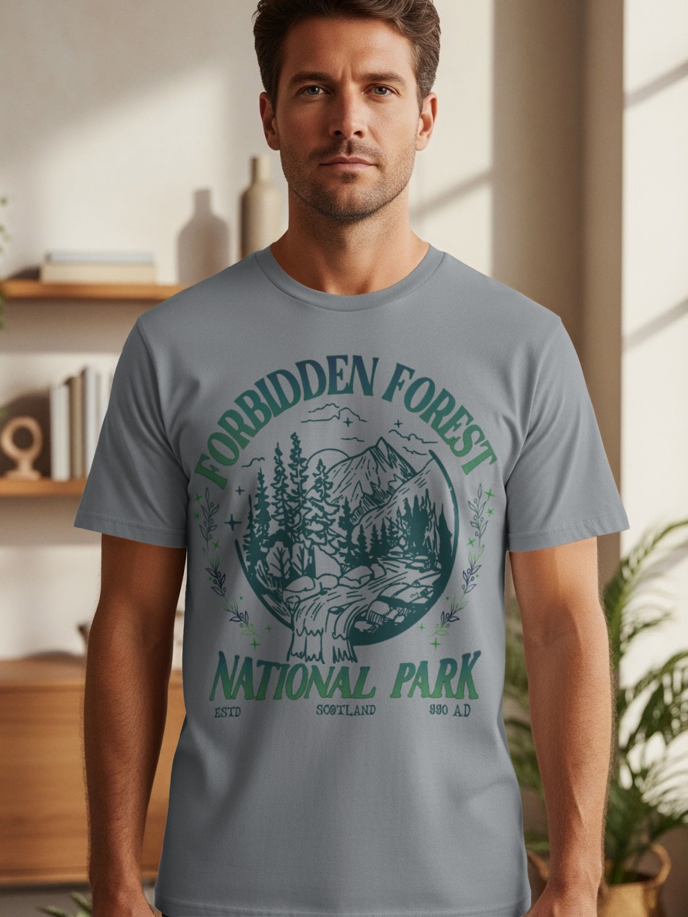 Grey t-shirt with "Forbidden Forest National Park Scotland" graphic featuring mountains and trees.