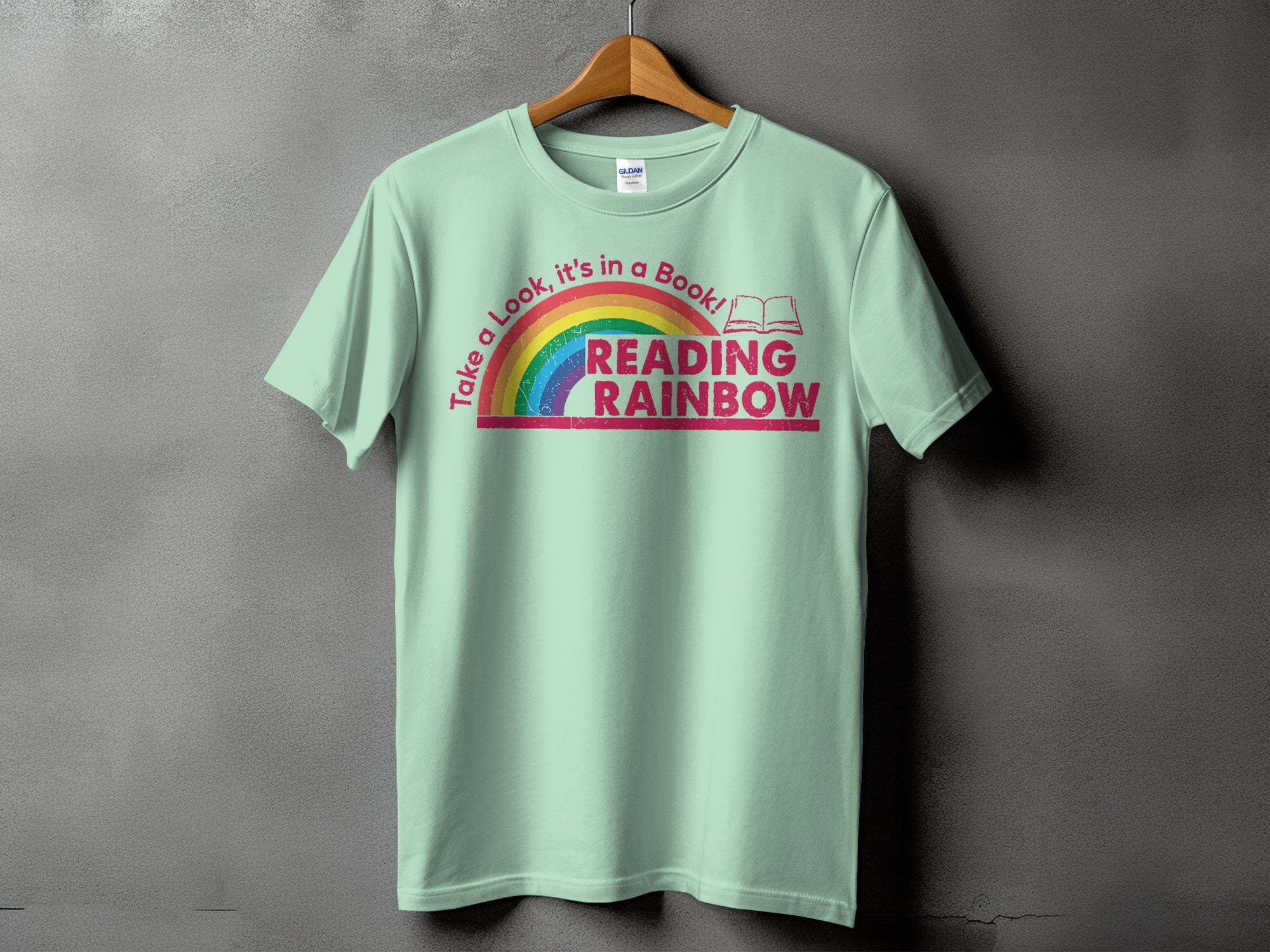 Light mint t-shirt with "Take a Look, it's in a Book! READING RAINBOW" text.