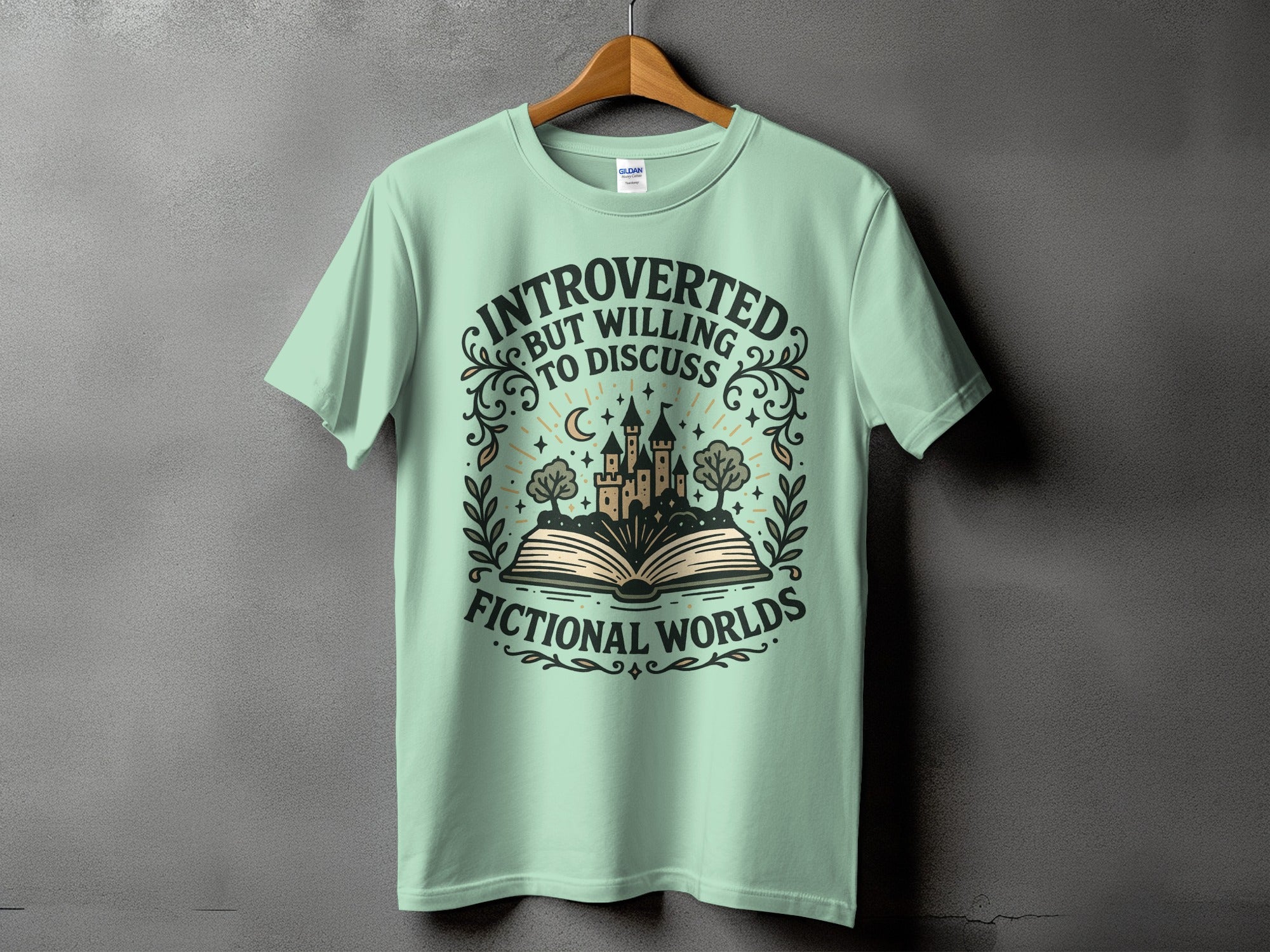 Mint green t-shirt with "Introverted but willing to discuss fictional worlds" text and castle design.