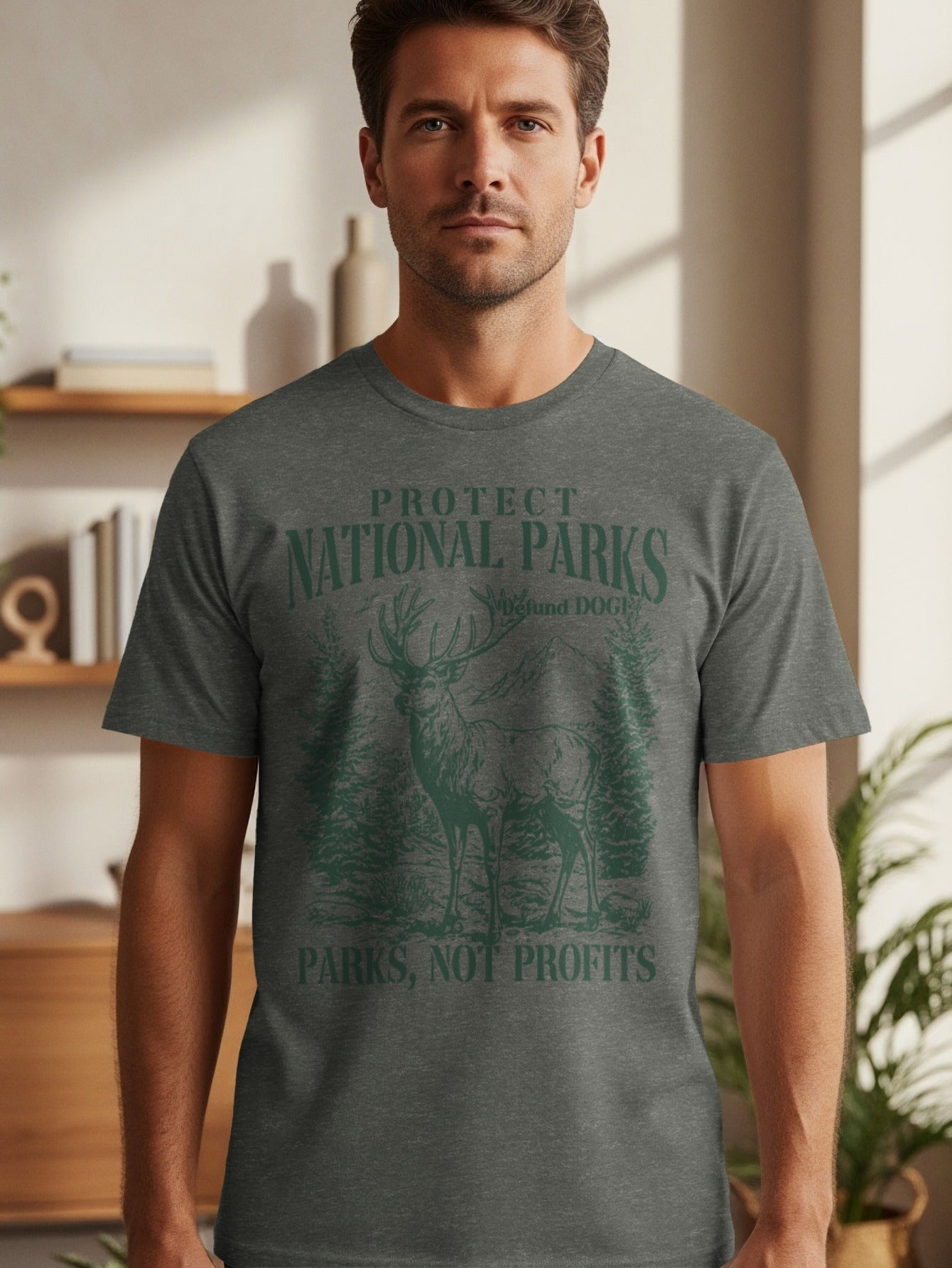Dark gray t-shirt with green text and graphic of a deer in a forest.