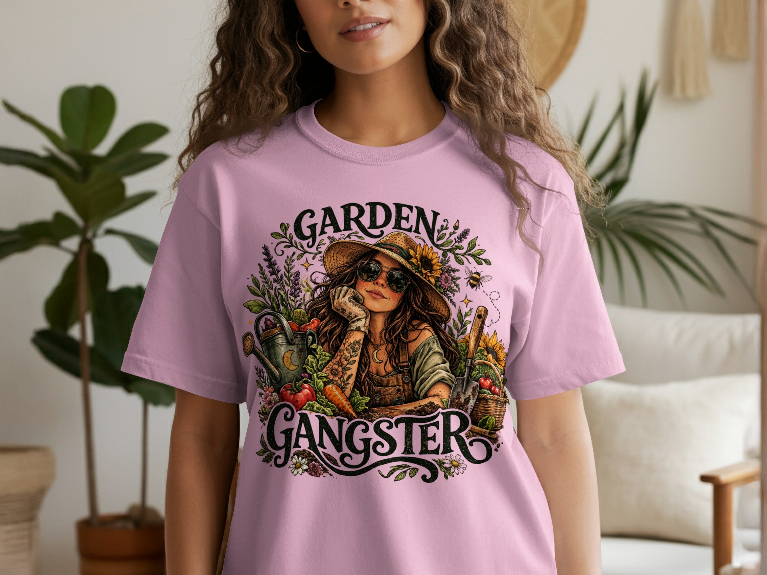 T-shirt with "Garden Gangster" graphic of a woman with gardening tools and vegetables.