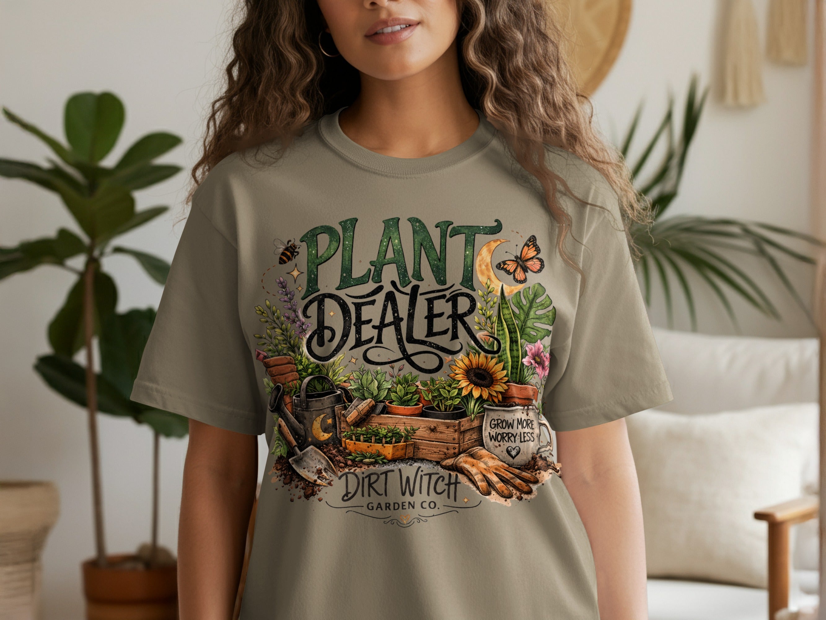 "Plant Dealer Dirt Witch Garden Co." text with gardening graphics on a t-shirt.