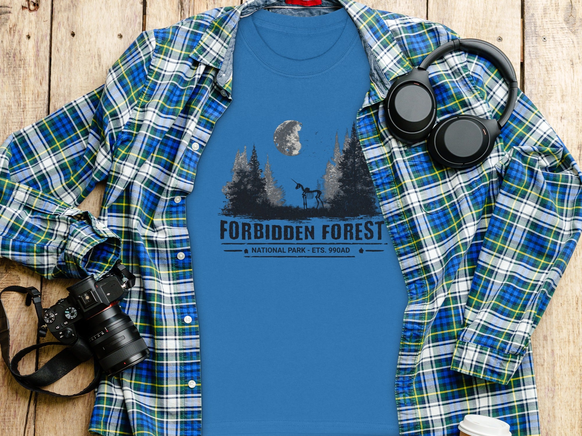 Blue t-shirt with "Forbidden Forest National Park" graphic and skeletal unicorn.