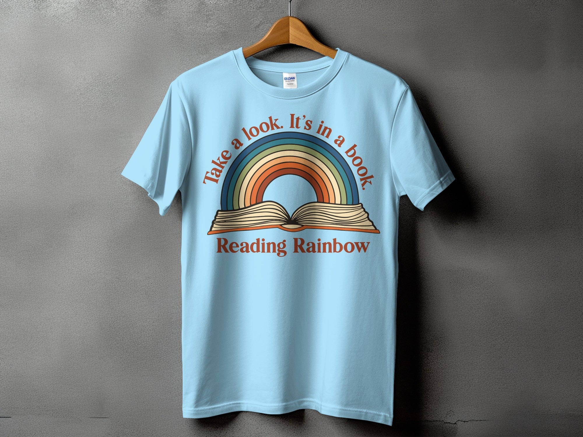 Light blue t-shirt with "Take a look. It's in a book" and "Reading Rainbow" text.