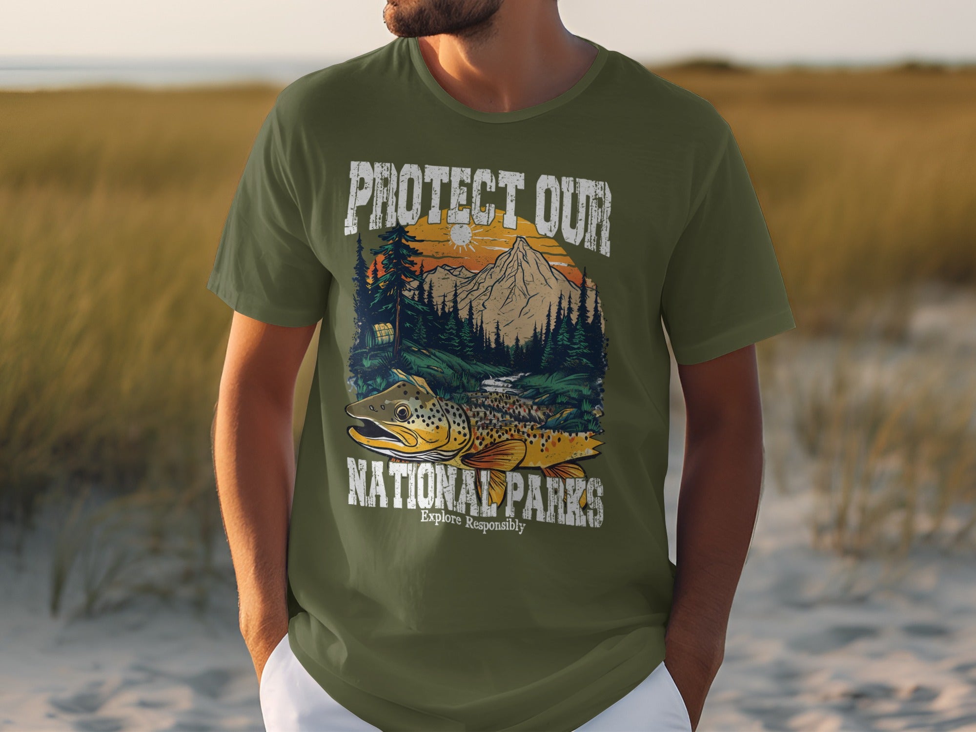 Green t-shirt features a fish, mountains, trees, and "Protect Our National Parks Explore Responsibly".