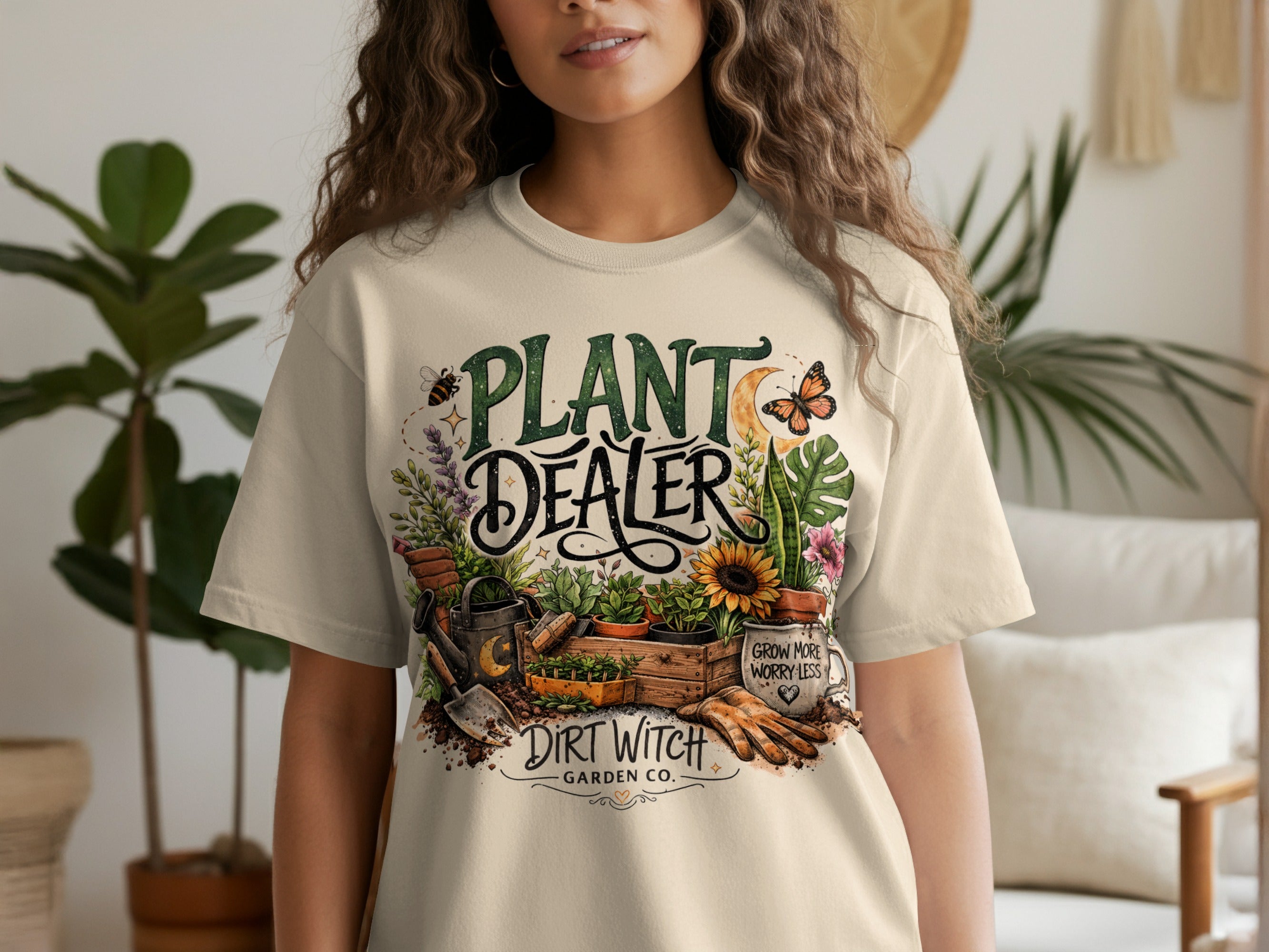 Cream t-shirt with "Plant Dealer Dirt Witch Garden Co." and gardening graphics.