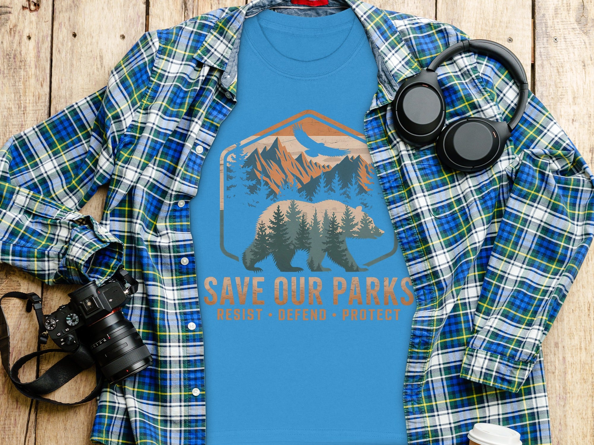 Blue t-shirt with a graphic of a bear and mountains, reading "SAVE OUR PARKS".