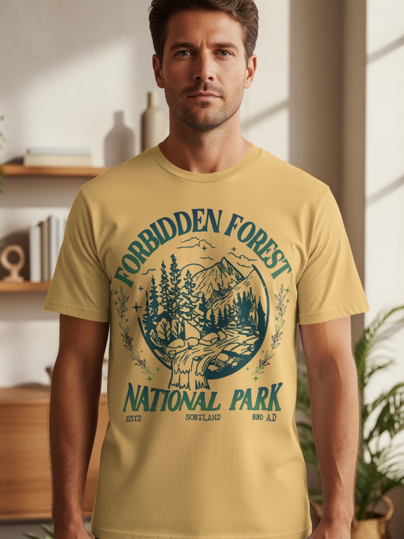 Yellow t-shirt with circular graphic of forest, waterfall, and mountains reading "Forbidden Forest National Park Scotland".