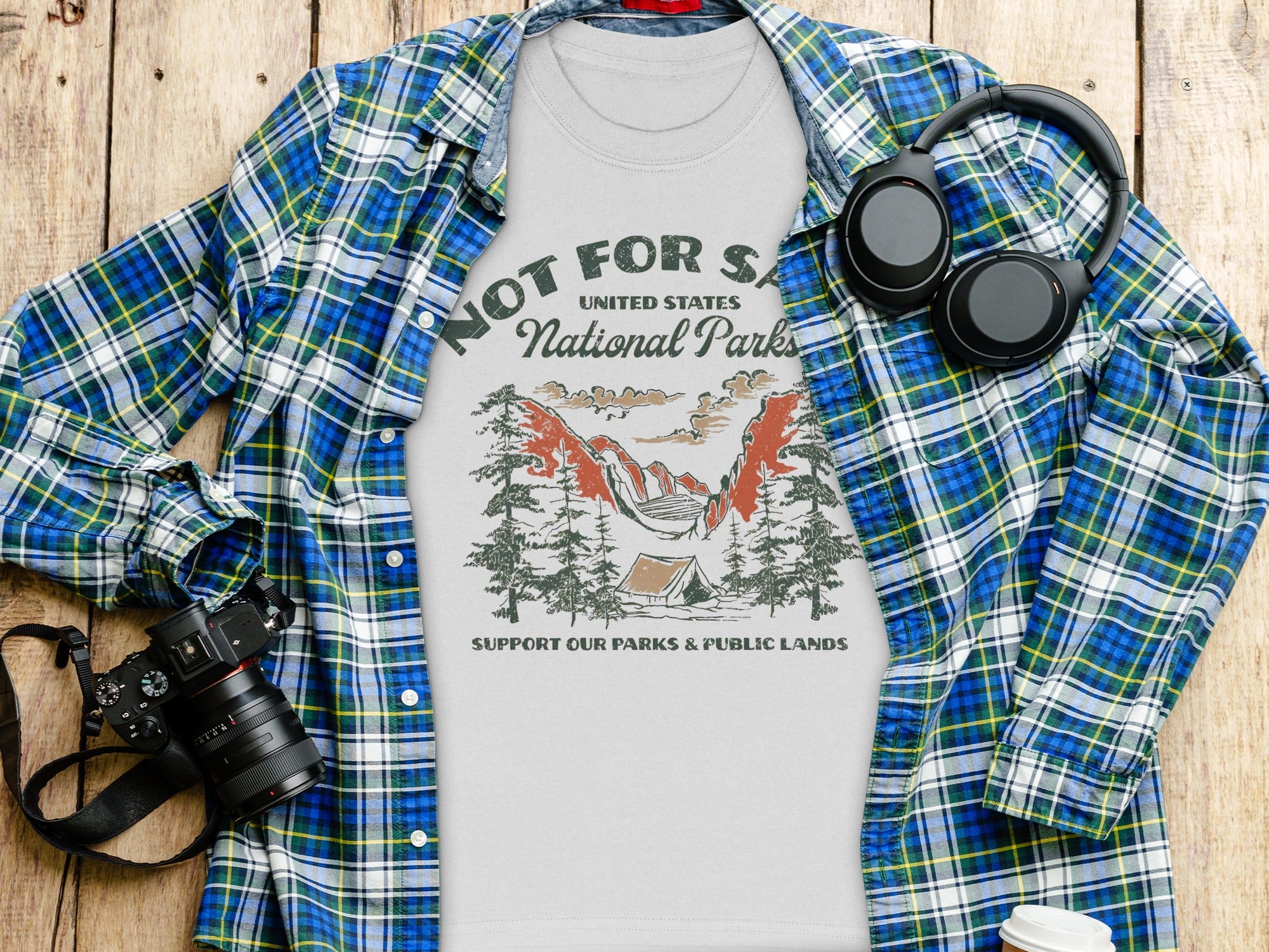 White t-shirt featuring National Parks graphic with camping scene and text.