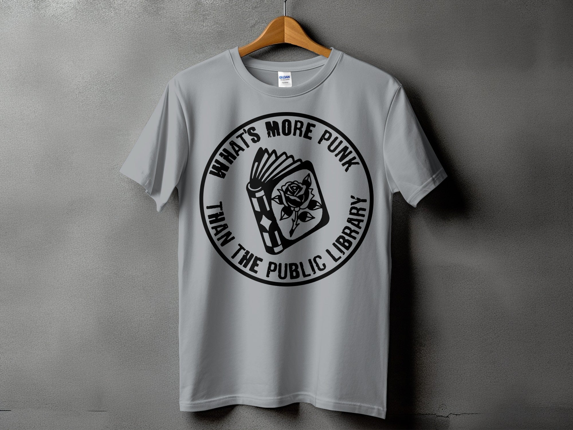 Gray t-shirt with black graphic of a book and rose, text "What's More Punk Than The Public Library."