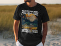 Black t-shirt with "Protect Our National Parks" text and a trout illustration.