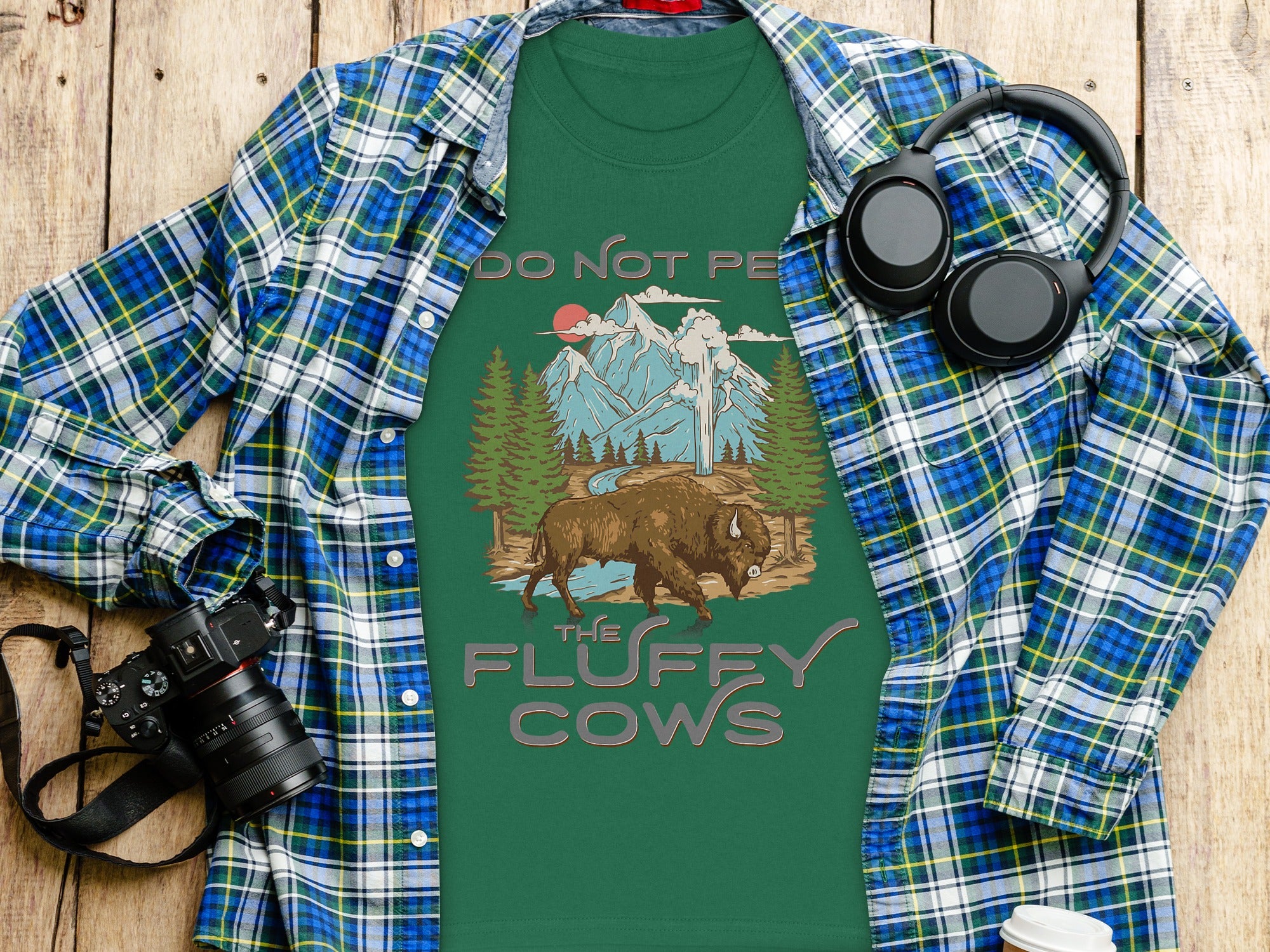 Green t-shirt with bison, mountains, and text "DO NOT PE THE FLUFFY COWS".