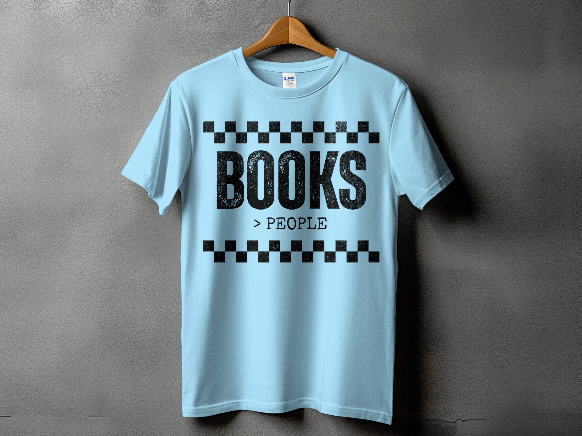 Light blue t-shirt with black text "BOOKS > PEOPLE" and checkered borders.