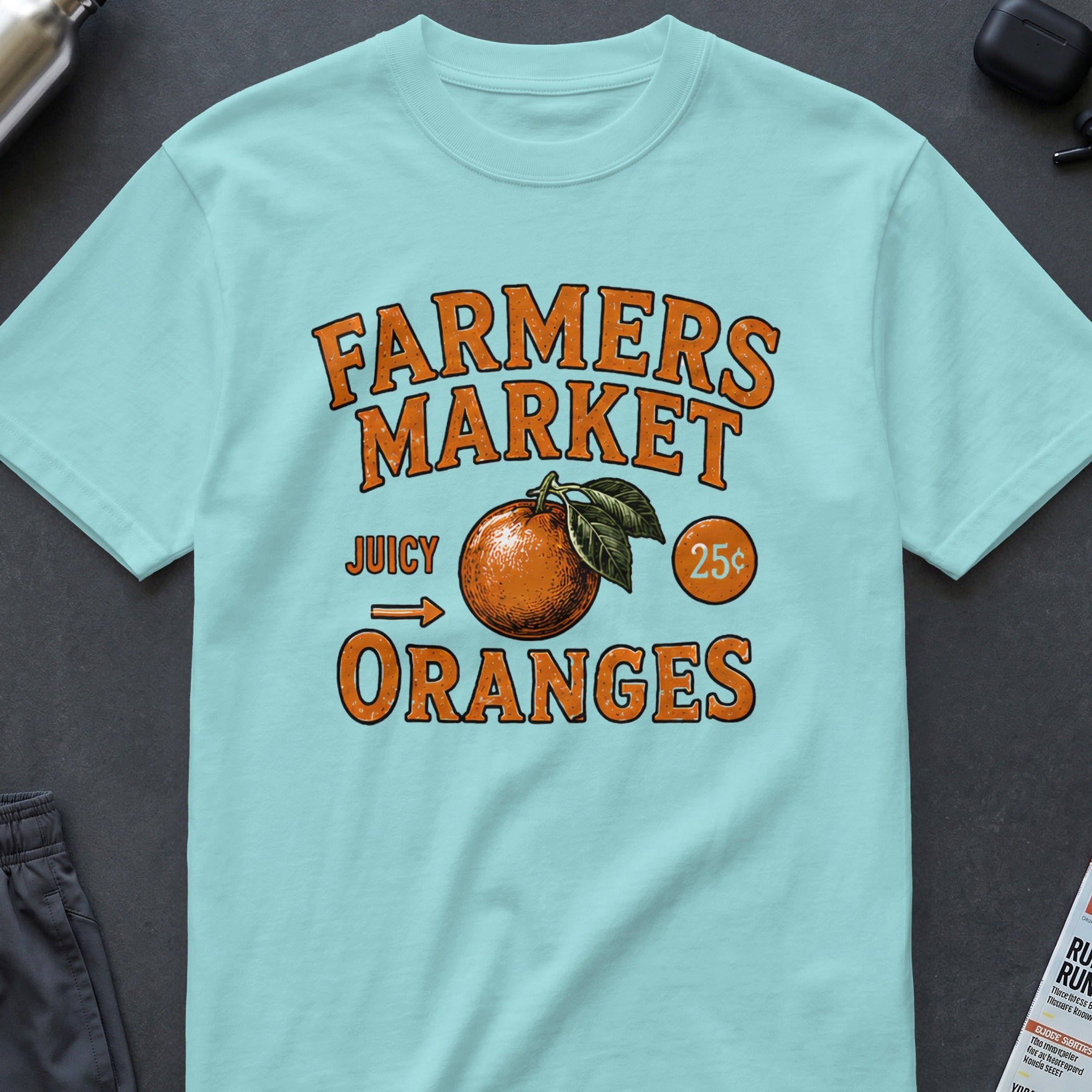 Light blue t-shirt with "Farmers Market Juicy Oranges 25¢" graphic.