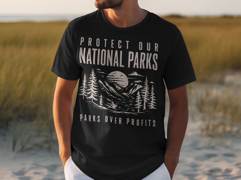 Black t-shirt with "Protect Our National Parks Parks Over Profits" text and mountain graphic.
