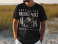 Black t-shirt with "Protect Our National Parks Parks Over Profits" text and mountain graphic.