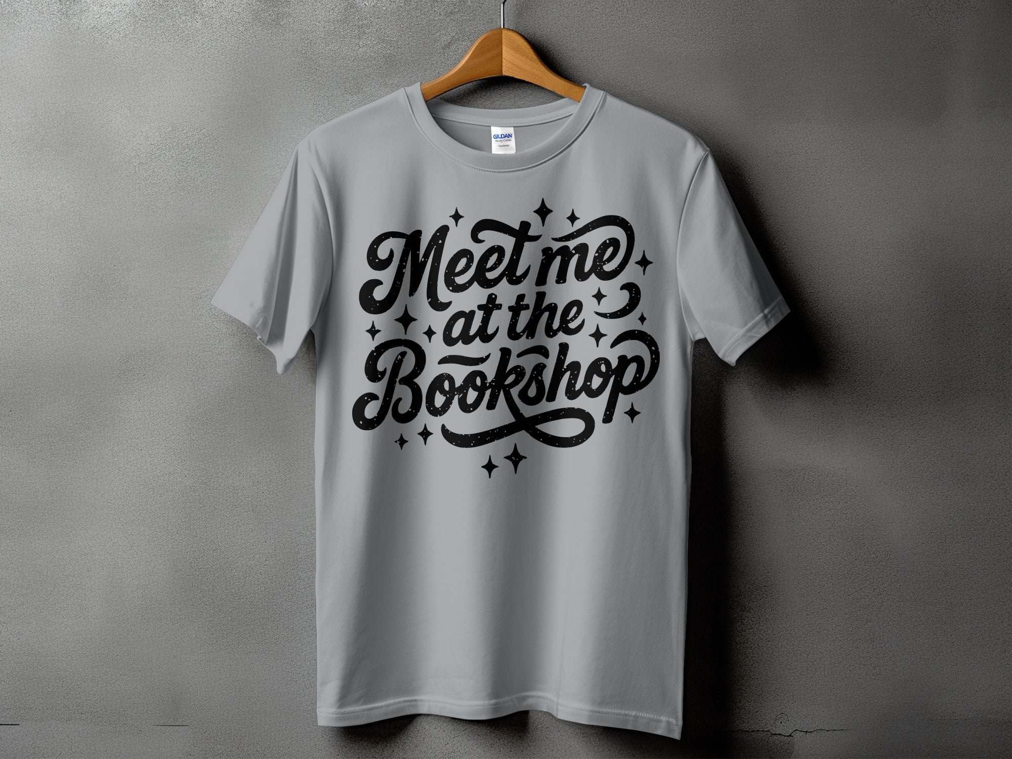 Grey t-shirt with "Meet me at the Bookshop" text and sparkles