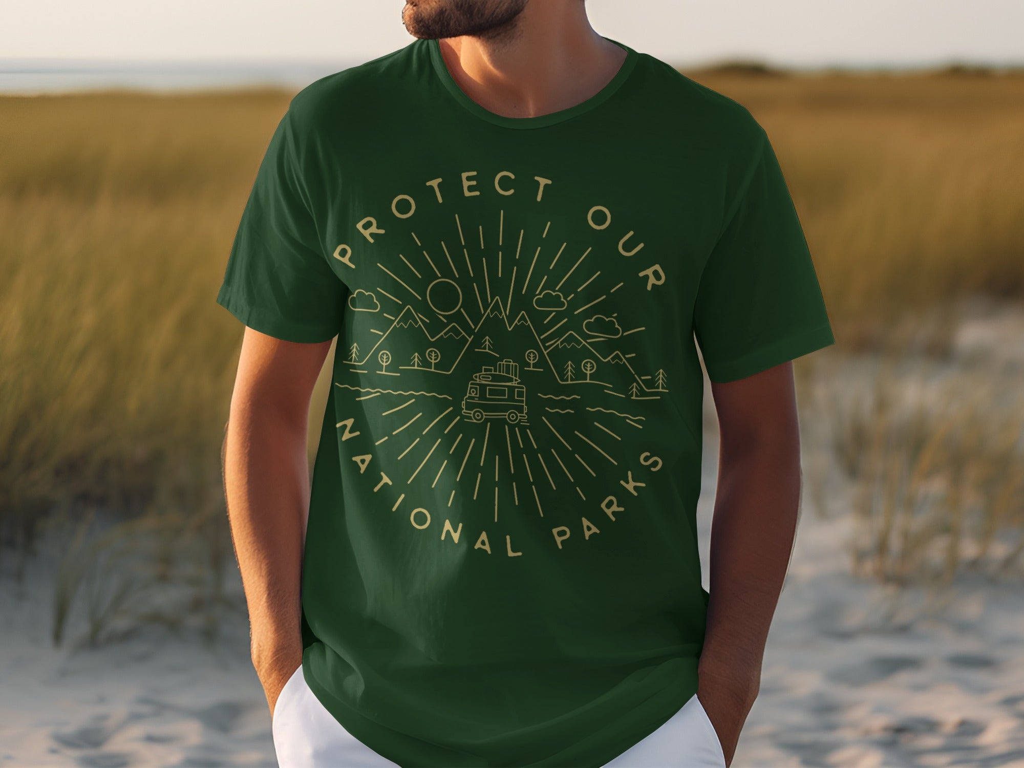Green t-shirt with "Protect Our National Parks" text and illustration of mountains, trees, clouds, and van.
