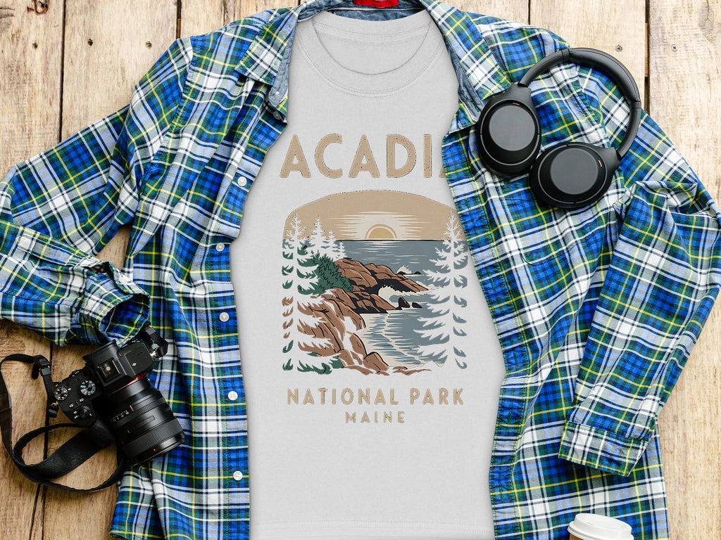 White t-shirt with Acadia National Park Maine graphic, paired with plaid shirt.
