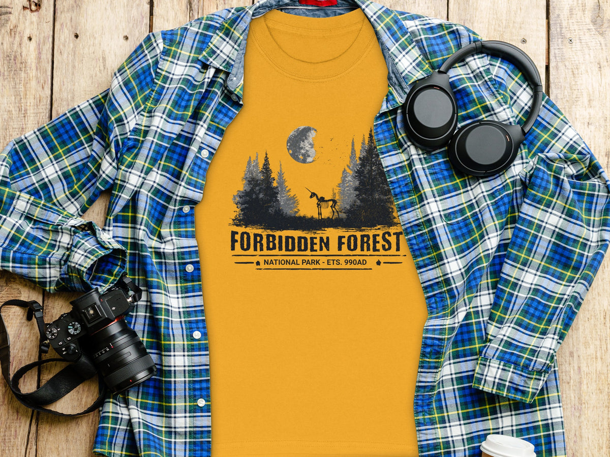 Yellow t-shirt with Forbidden Forest National Park graphic and skeleton unicorn under moon.