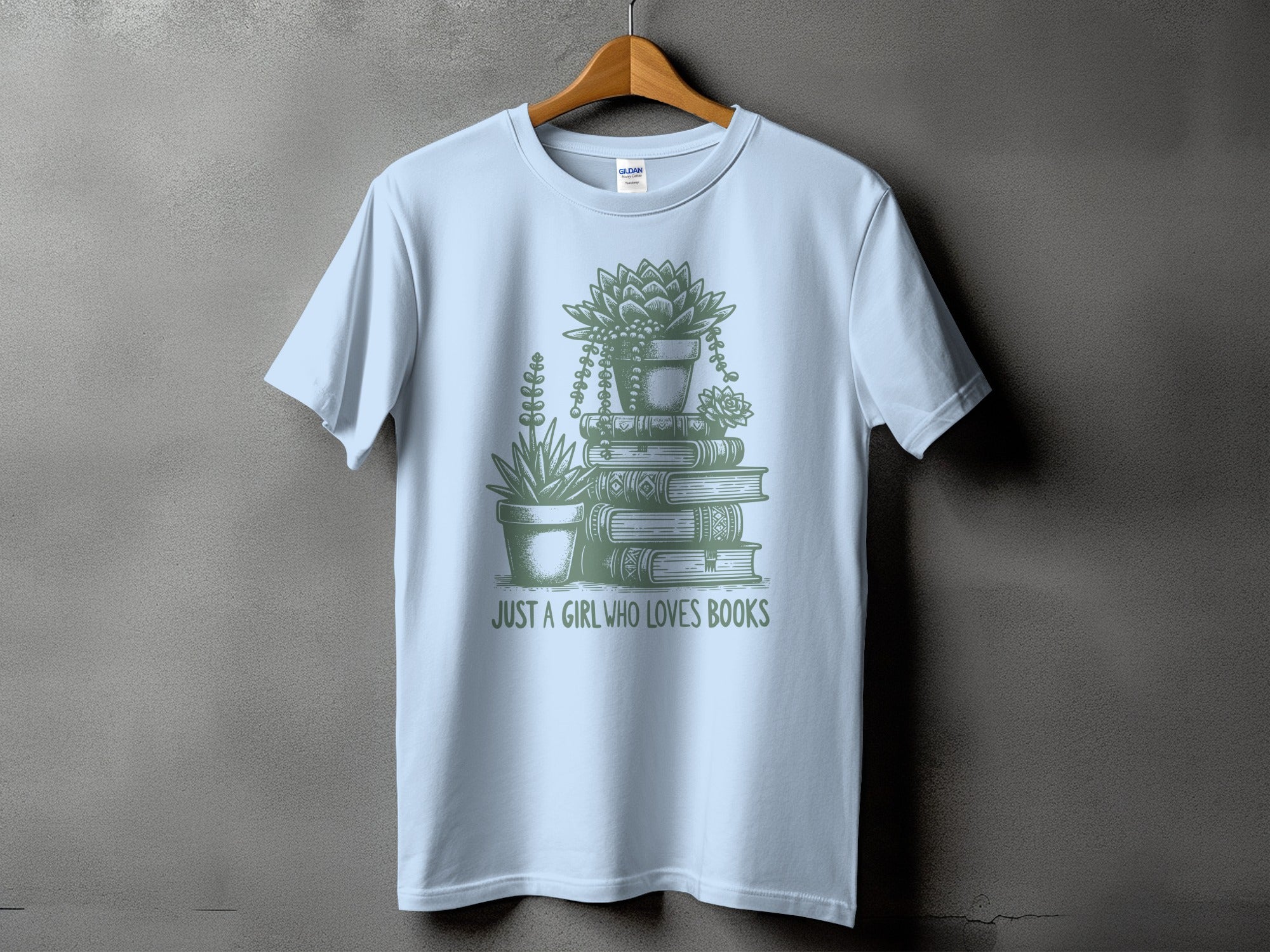 Light blue t-shirt with stacked books and plants graphic, "Just a Girl Who Loves Books".