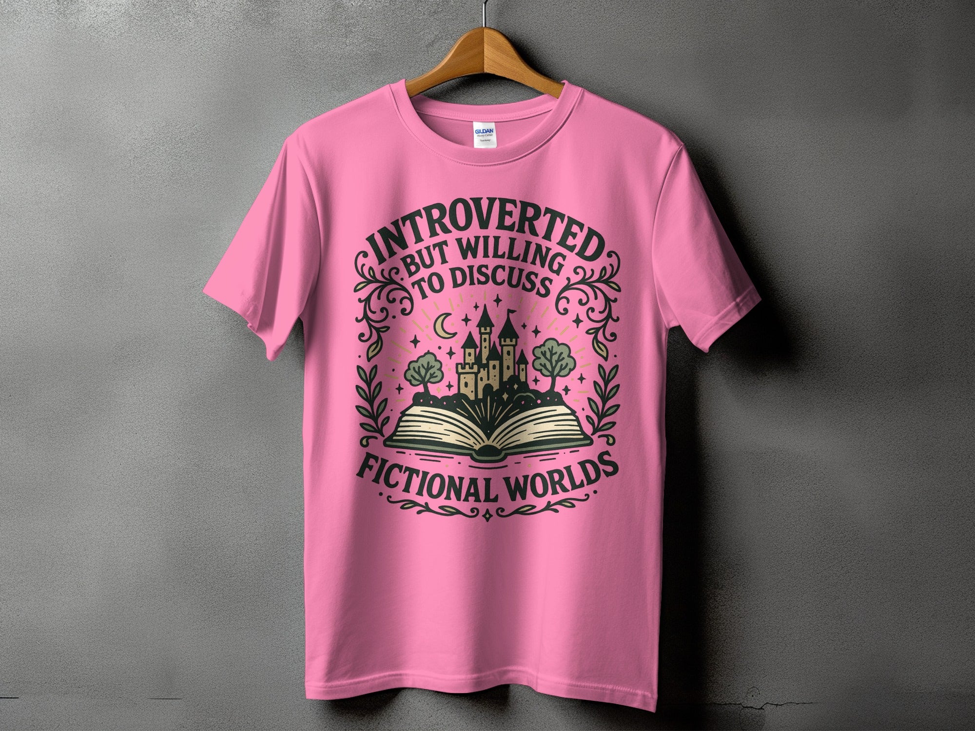 Pink t-shirt with design: "Introverted but willing to discuss fictional worlds".