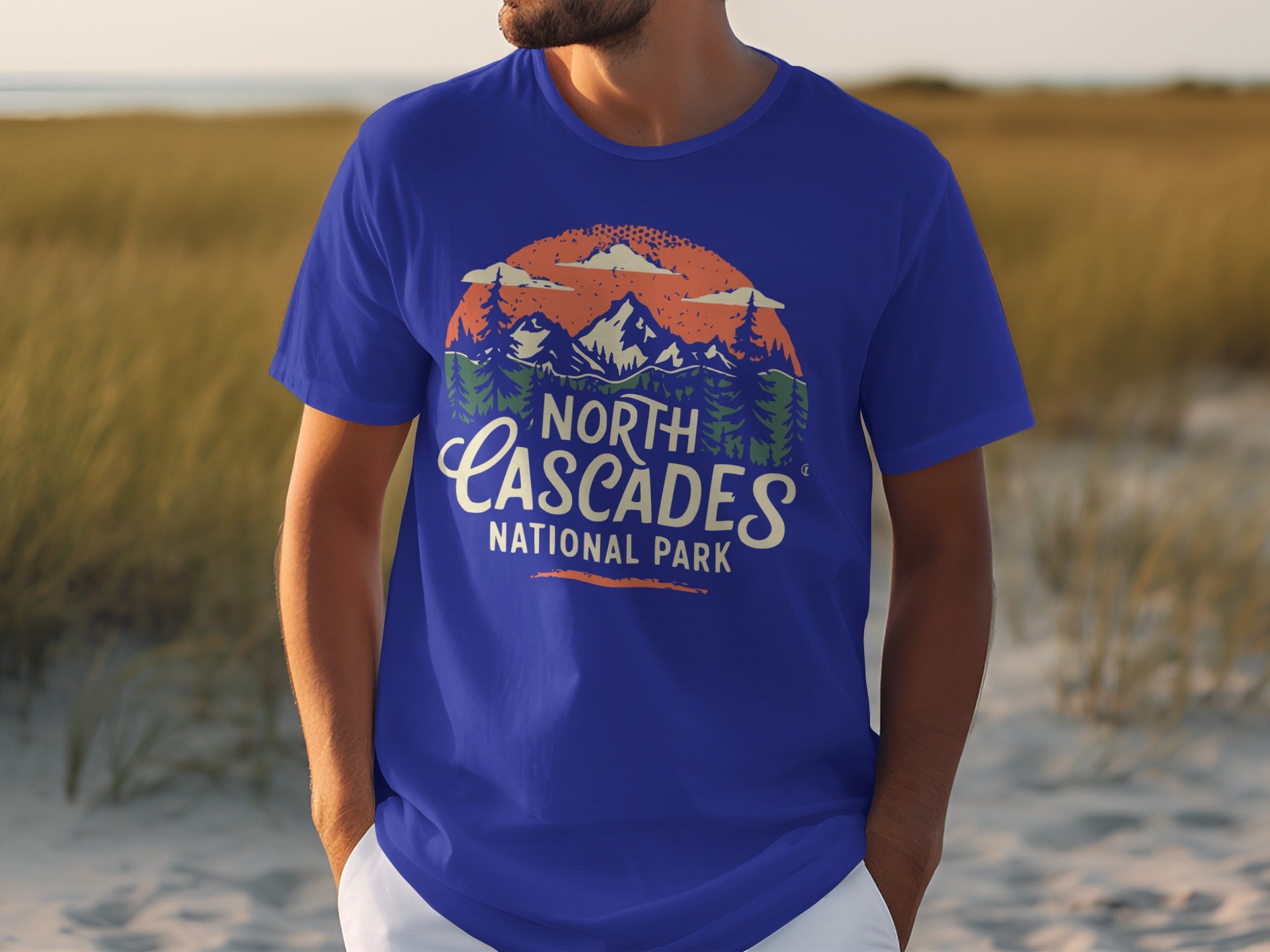 Blue t-shirt with North Cascades National Park graphic featuring mountains, trees, and clouds.