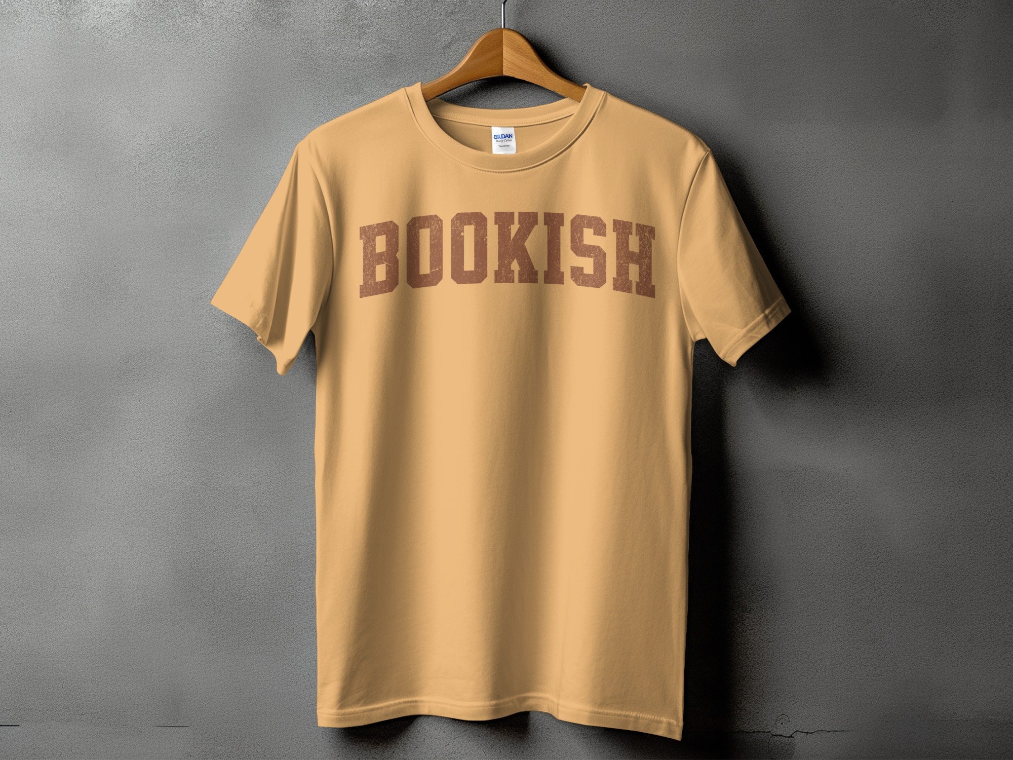 Tan t-shirt with "BOOKISH" printed across the chest in distressed brown letters.