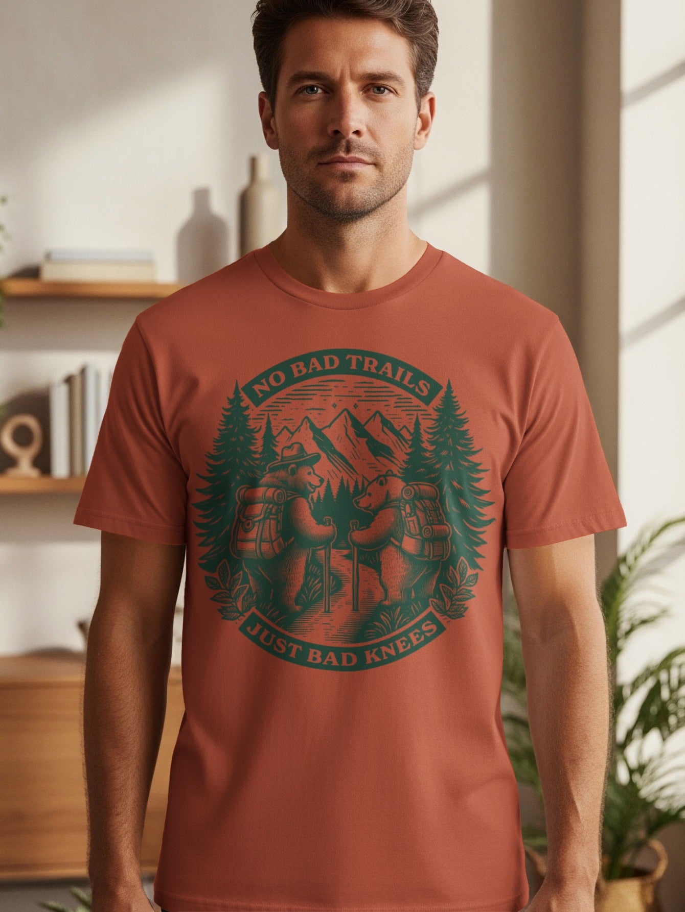 T-shirt graphic with bears hiking in mountains and text "NO BAD TRAILS JUST BAD KNEES".