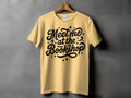 Yellow t-shirt with black text "Meet me at the Bookshop" and star accents.