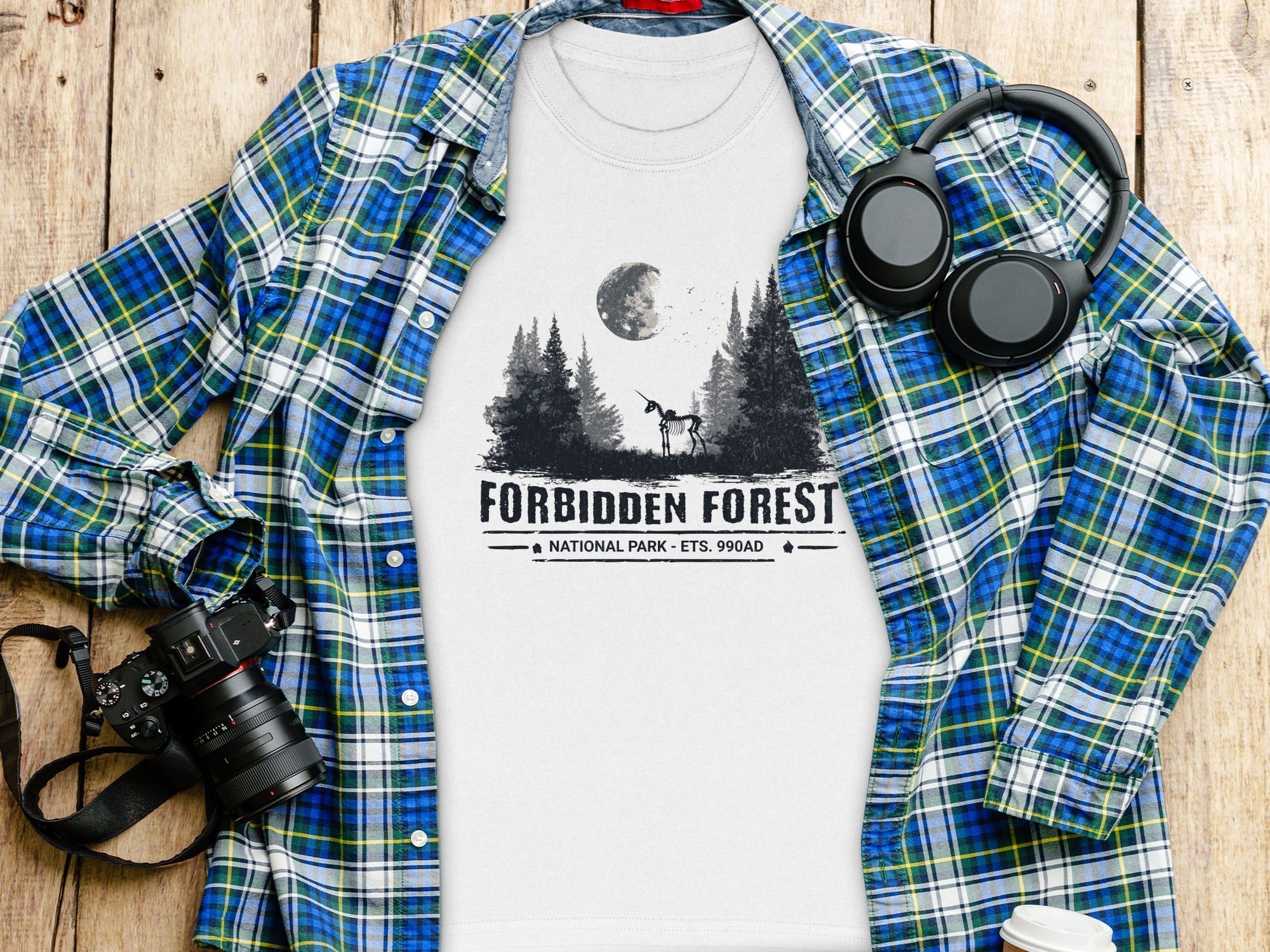 White t-shirt with "Forbidden Forest National Park" graphic and skeleton unicorn.