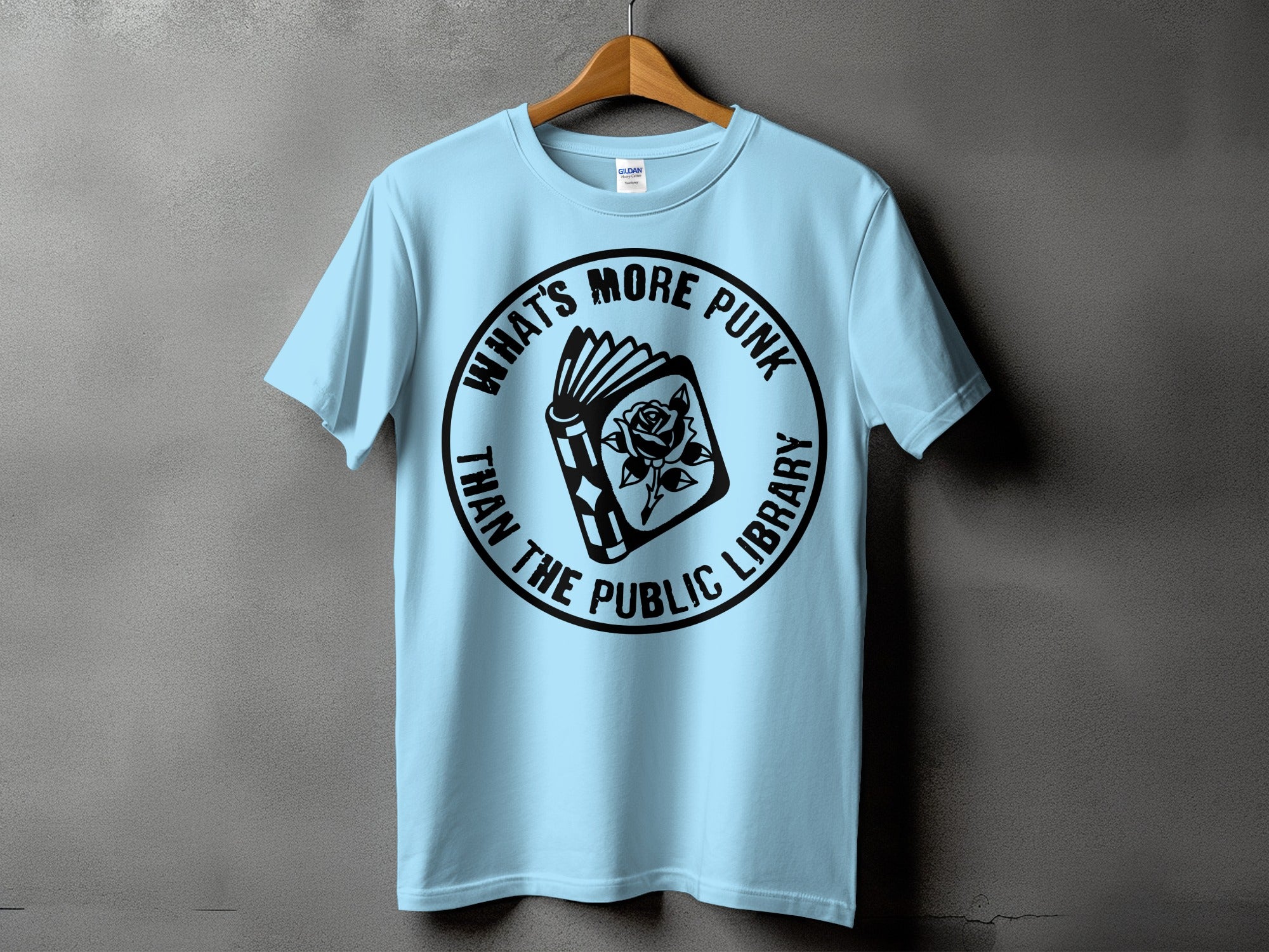 Light blue t-shirt with circular black graphic: "What's More Punk Than The Public Library."