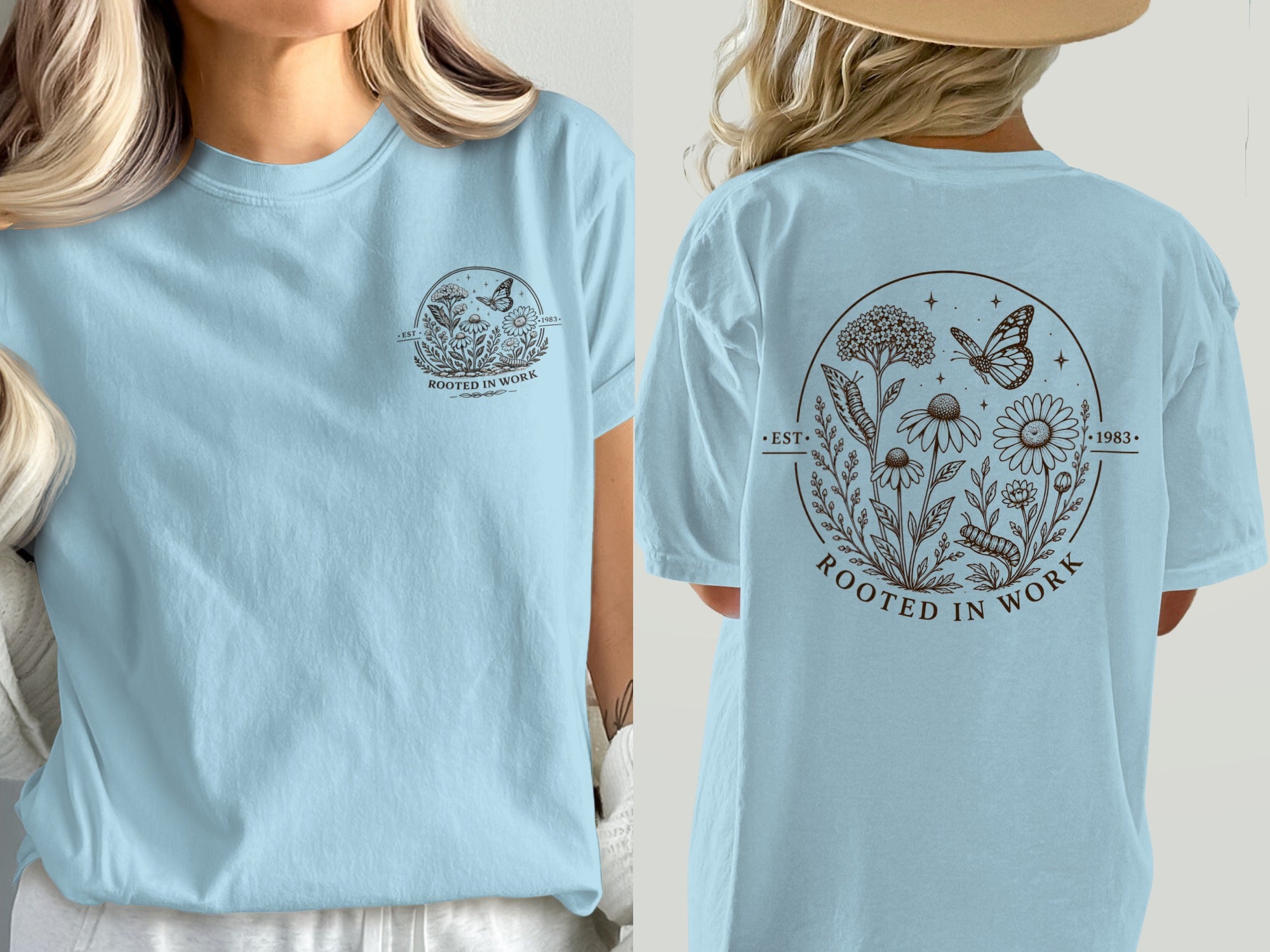 Light blue t-shirt with circular floral and insect graphic reading "ROOTED IN WORK".