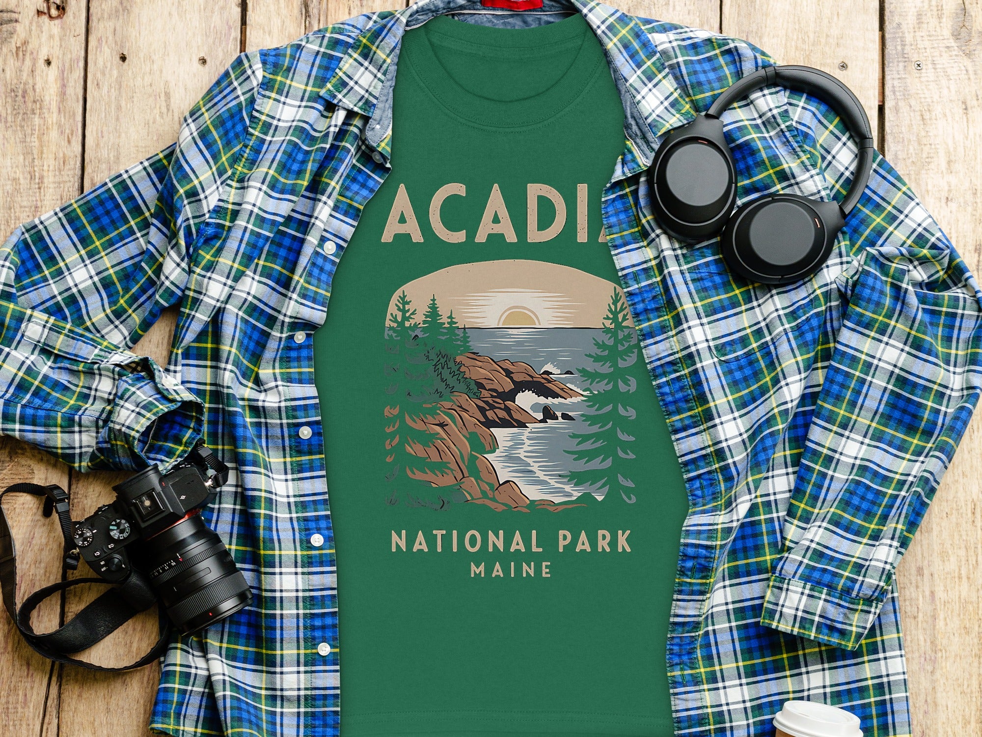 Green t-shirt with "Acadia National Park Maine" graphic and plaid shirt.