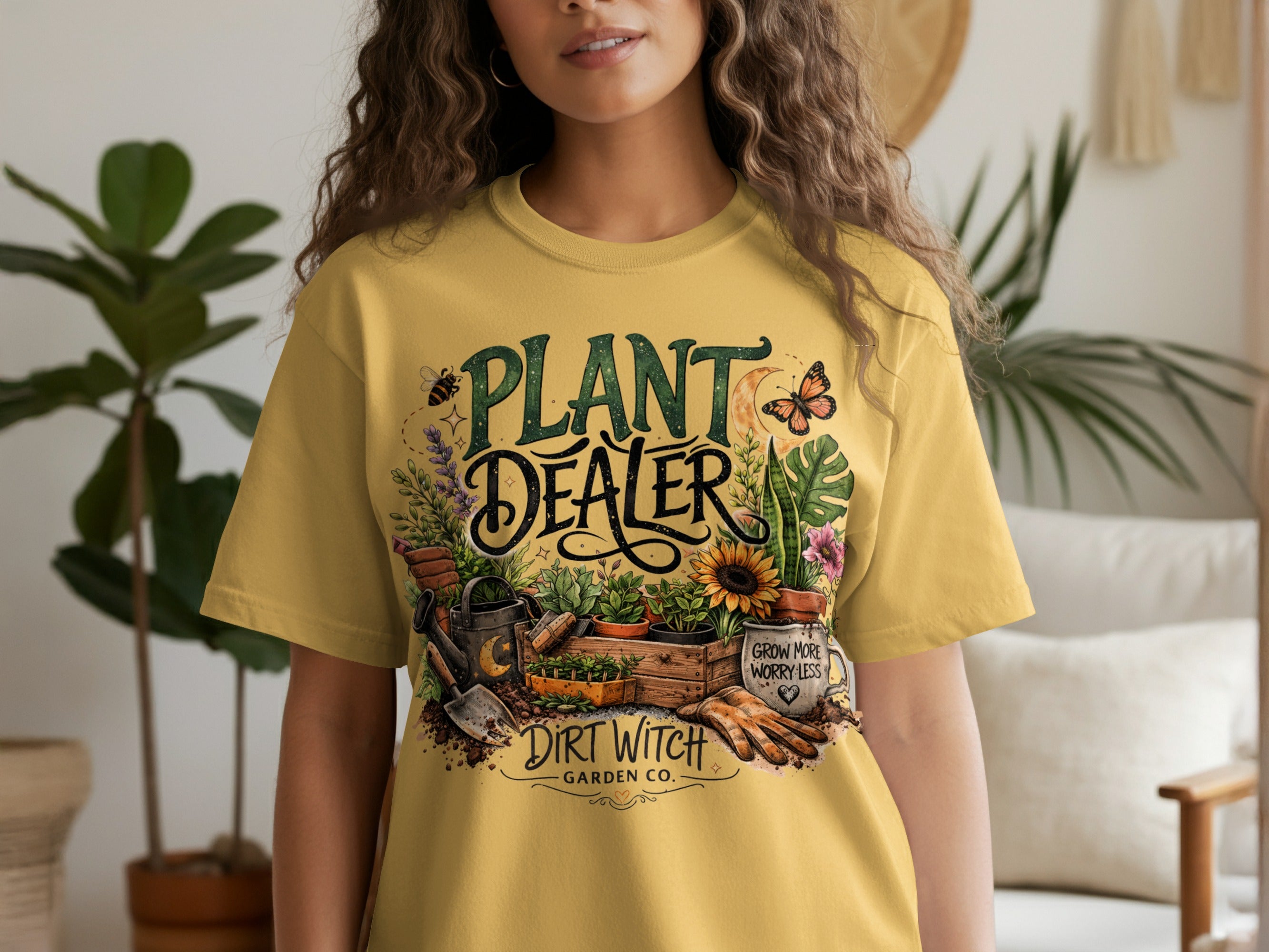 Yellow t-shirt with "Plant Dealer" and "Dirt Witch Garden Co." text, gardening graphics.