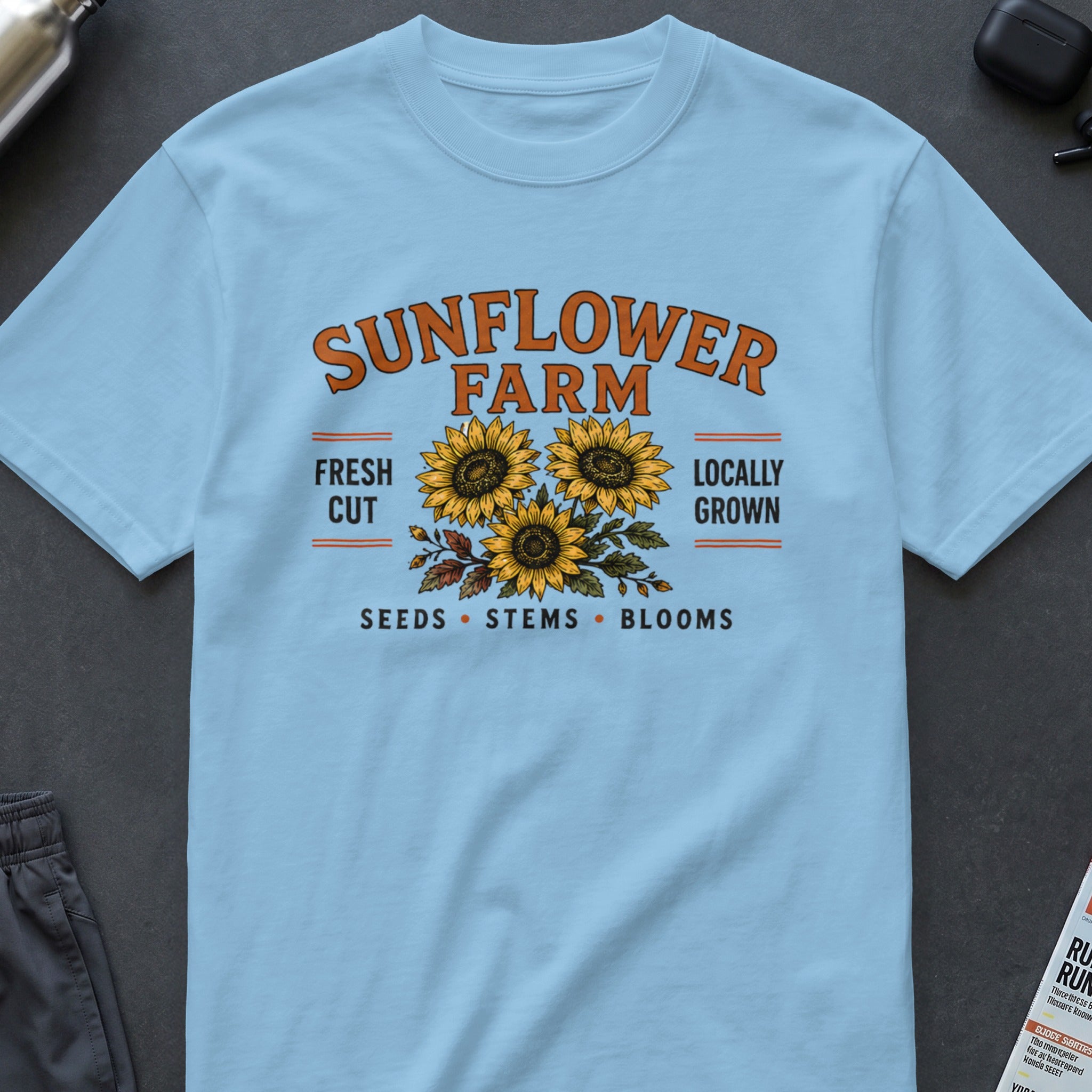 Light blue t-shirt with "SUNFLOWER FARM" and sunflowers graphic.