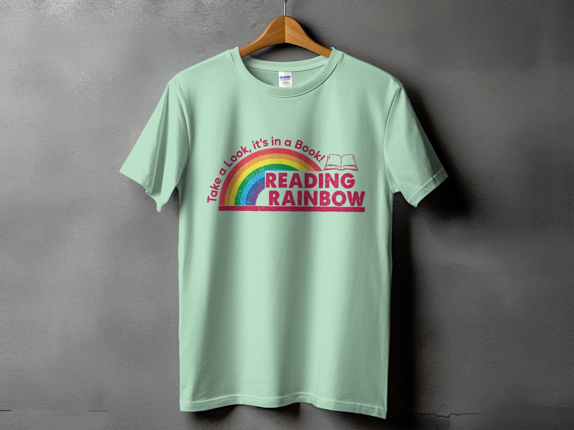 Light green t-shirt with rainbow and "Reading Rainbow" text.