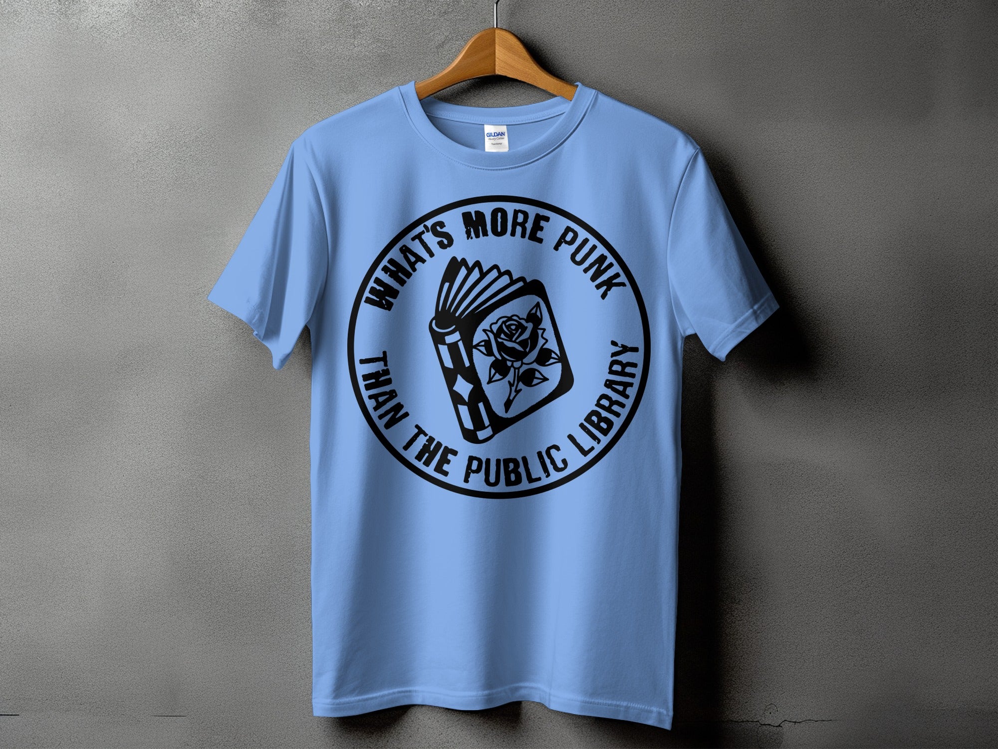 Light blue t-shirt with black circular graphic of an open book and rose.