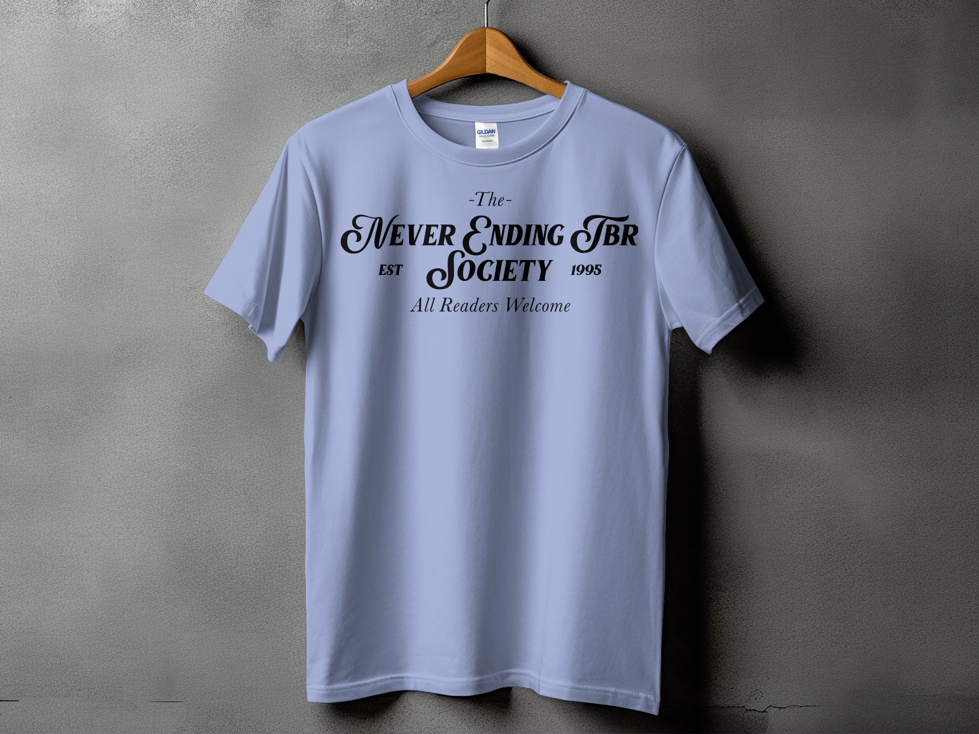 Light blue t-shirt with "The Never Ending TBR Society Est 1995 All Readers Welcome" text.