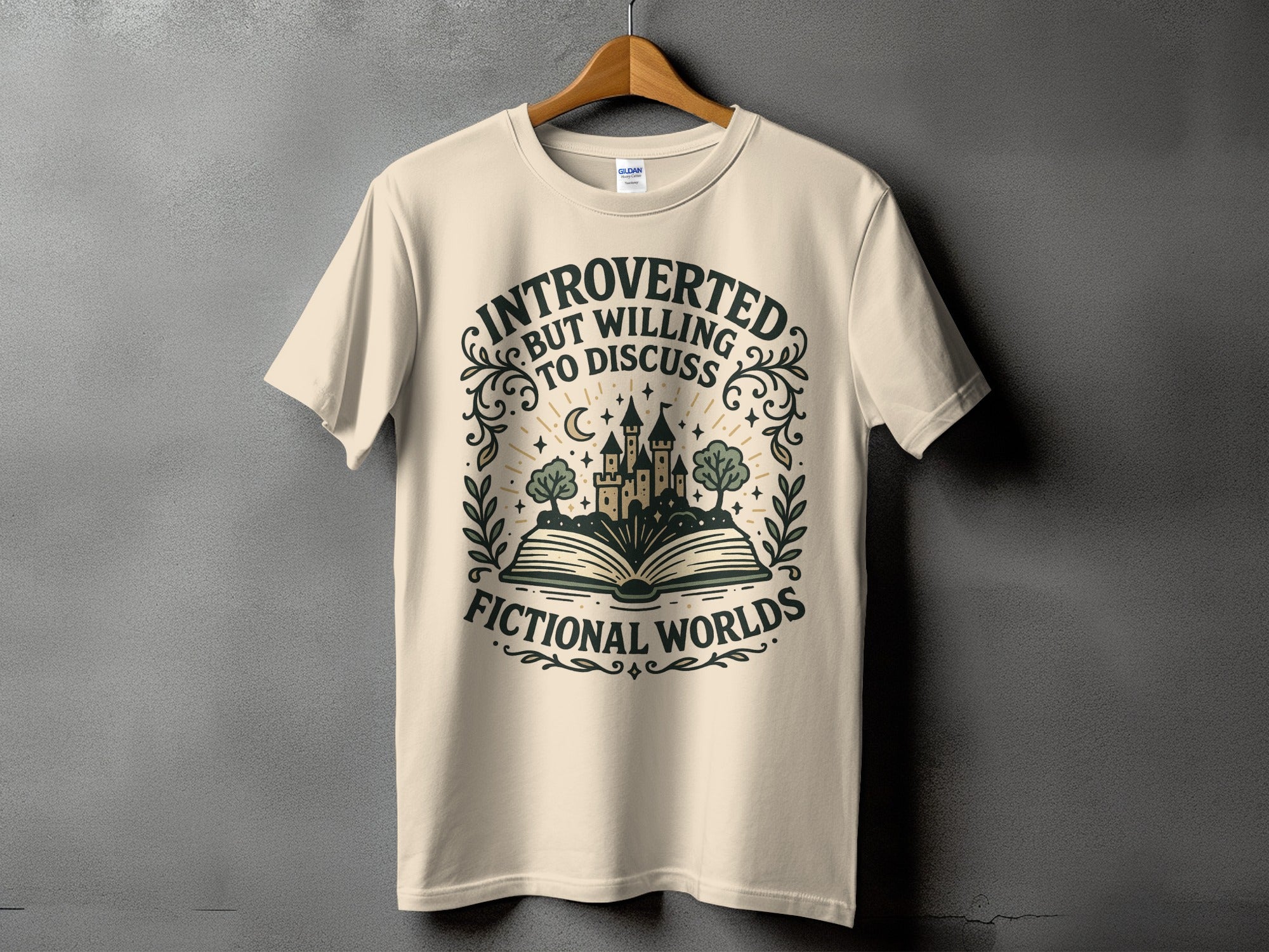 T-shirt with text "introverted but willing to discuss fictional worlds" and graphic.